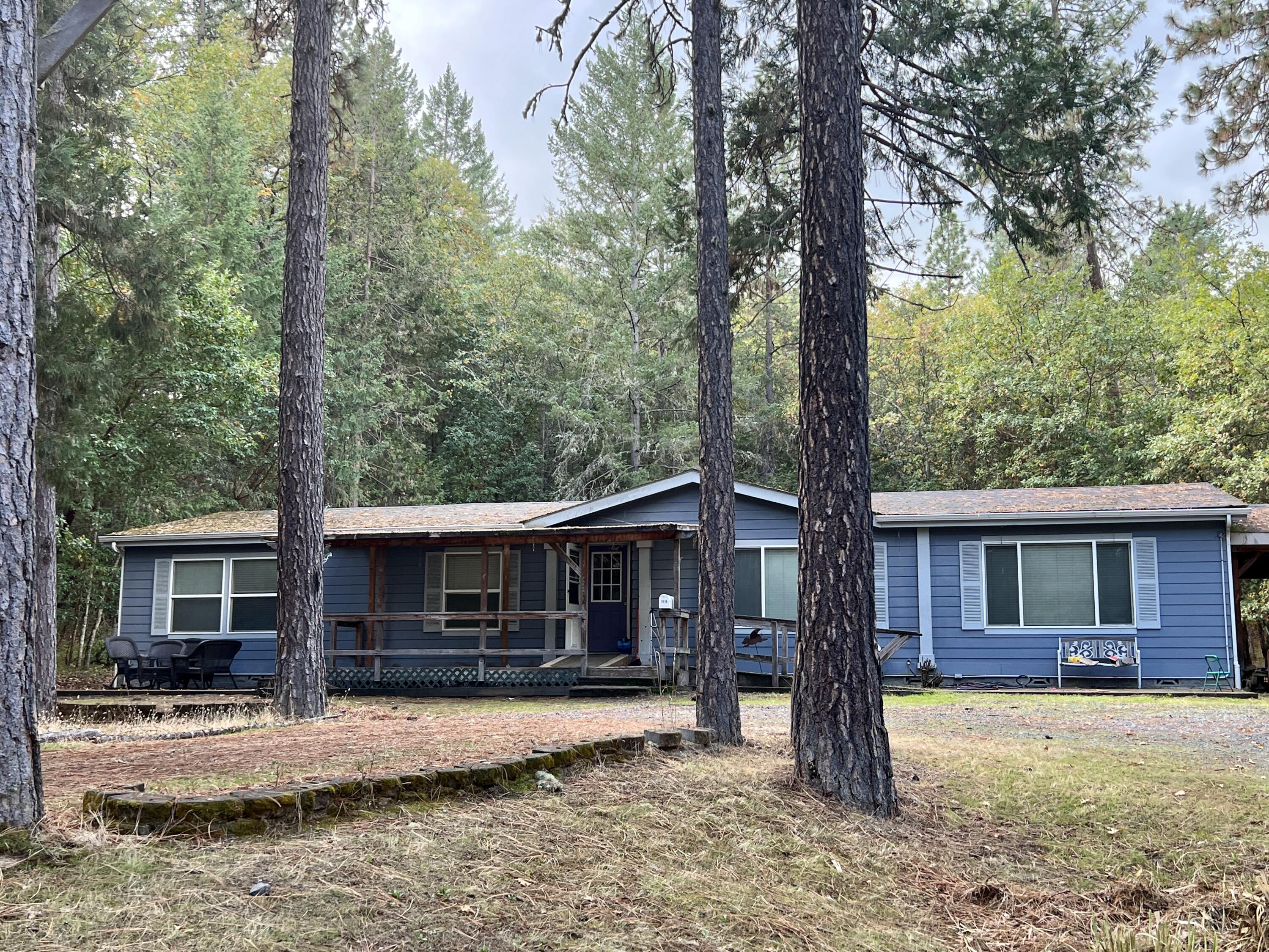 Here's your opportunity for that special property with a rural feel, that's just minutes from town.  This spacious 2200 square ft. home includes 4 bedrooms and 2 bathrooms, with a bonus room/office.  Plus, the house is set up for split living with bedrooms separated on each side. The large primary bathroom has double sinks and vanities, with both a shower and soaking tub. There are two gathering spaces, both a living room and den.  The large kitchen has lots of cupboard space with an island counter/sink. There's also a separate dining room off of the kitchen and a dedicated laundry room.  Outside you'll find 3 and a 1/4 acres, tucked off of the road with a private driveway.  There are several outbuildings, an attached carport, and two areas set up for RV's. 
Listing agent is related to seller.