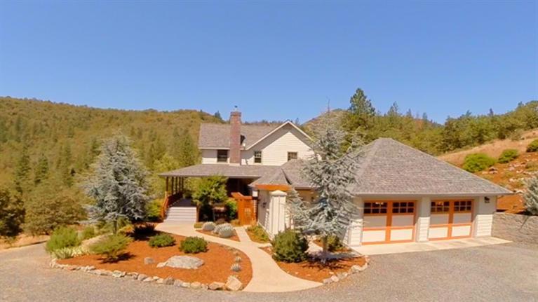 Serene, secluded & private, high speed broadband internet, cell service and all of the living on the first floor. This stunning home, high above the trees will take your breath away with it's majestic views and quality craftsmanship. Beautiful solid oak flooring, and woodwork throughout. Great well. Warm living room with tray ceilings and brick fireplace. Farm chic kitchen with stainless appliances, bright cabinetry, and granite counters. Gorgeous master suite on the main floor with two walk-in closets and a master bath to die for, complete with soaking tub and views. Upstairs is another master suite with full bath and 2 more bedrooms and a full bath along with a bright and sunny loft/office area. Fabulous wraparound deck to enjoy the views. Home is solar powered which all but covers the cost of power. Beautiful landscaping, garden area, 2 seasonal creeks and vineyard with 100 vines. 2 car detached garage with small studio and another 1 car detached garage. Owner financing available.