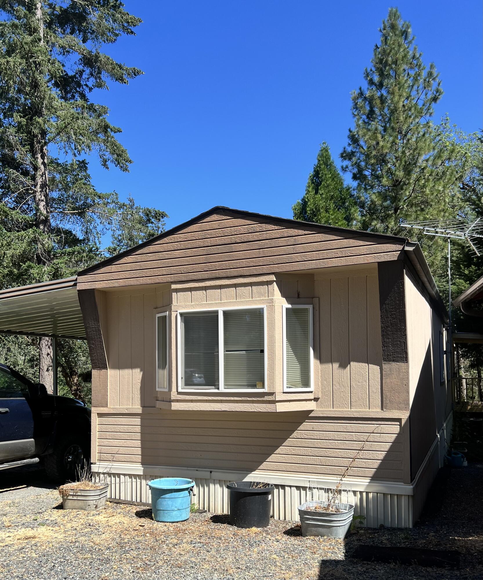 1997at th MFH only.  924 sq.ft 2 bedroom, 2 bath split floorpan. Home appears to be in good shape and was installed as a hardship placement at the property from the dealers  lot in 1997.  Must be moved. 
Home being sold as is in its current condition. Seller to do no repairs if needed. Roof is original but no leaks.  Move and  live in while you build on your land. Or move to your land property and or replace an older model MFH with this 1997 home. Primary bedroom is spacious. Lots of storage throughout. Included in the sale are all appliance, carport awning, porches, heat pump. 
This home must be moved from its current location. Buyer to perform their own due diligence into all aspects of the home including the condition and the cost and logistics of moving.Mover/buyer will need to provide axles etc for the move. They had been removed when placed at this location.