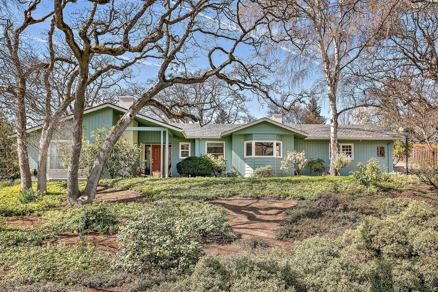 Sought after Old East Medford gem on half an acre lot is a meticulously maintained four bedroom, three bath home in a quiet neighborhood. A beautiful slate floor entryway greets you at the front door, adjacent is a lovely sunken formal living room with wood burning fireplace and hardwood floors. The open kitchen has been newly renovated, equipped with stainless steel appliances. Flow into the Great room featuring picturesque windows to view the charming backyard, cozy gas burning fireplace, formal dining area and airy vaulted ceilings. Spacious master suite with walk in closet along with separate access to the delightful backyard. Mature landscaping with in-ground sprinklers and wrap around paver patio to enjoy morning coffee or evening BBQ's! This home has newer electrical, HVAC system, fresh paint and new flooring throughout. Truly a well loved and cared for property inside and out, don't miss out on this amazing home!