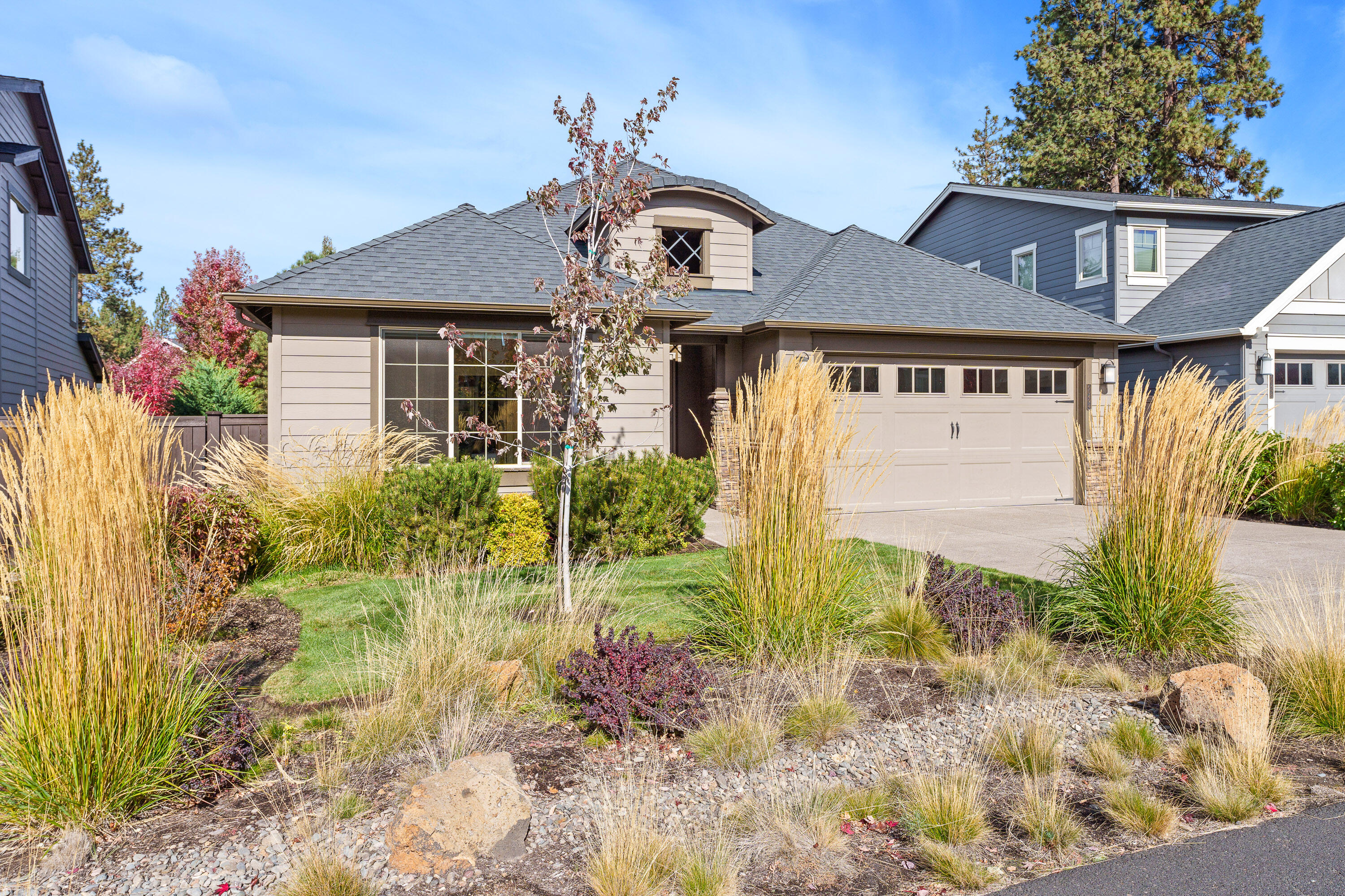 Immaculate single-level living in the desirable Stonegate community of SE Bend! This home feels brand new yet comes complete with thoughtful upgrades, including window coverings, an air treatment system, and a low-maintenance landscaped backyard. The light-filled great room impresses with vaulted ceilings, skylights, and expansive windows that bring the outdoors in. The chef's kitchen showcases granite counters, SS appliances—including a cooktop, wall oven, microwave, and refrigerator—and hardwood floors, while the roomy primary suite offers a tiled walk-in shower for a touch of luxury. A private guest room ensuite provides comfort and convenience for family and friends. Step outside to a fully fenced backyard with gate access to neighborhood walking paths and open space. Added bonus: custom cabinetry in the garage for exceptional storage and organization. Move-in-ready perfection!