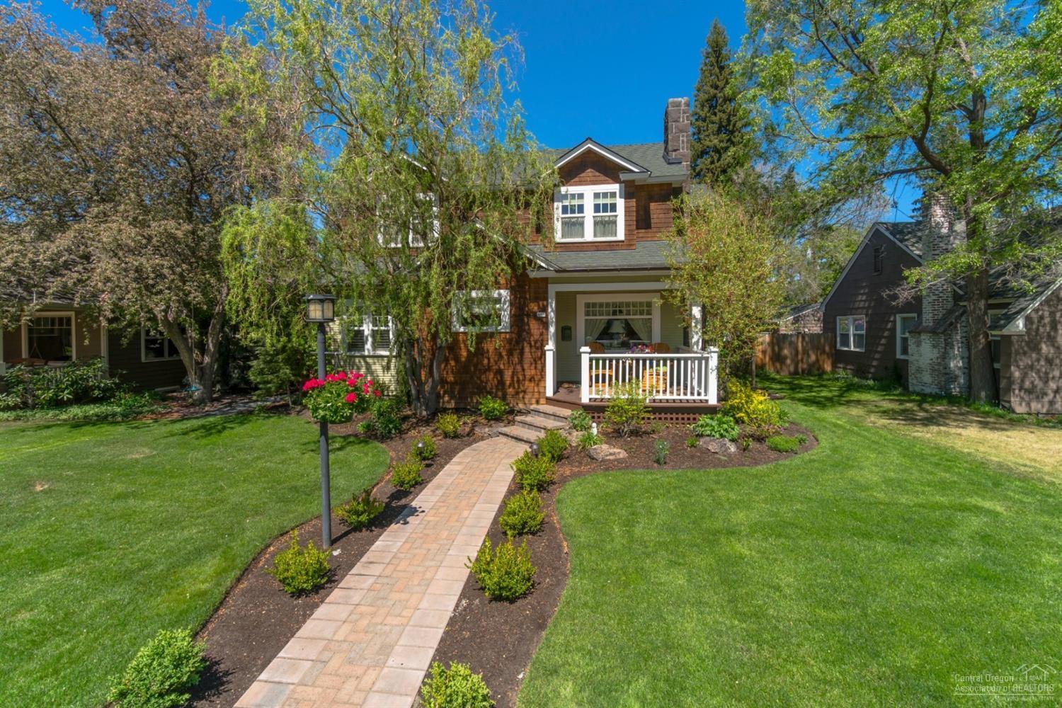 Enjoy watching the world go by while sitting on the front porch of this one-of-a-kind historic home located in the heart of Bend, or the peaceful, private tranquility of the English garden setting in the back yard adorned with lit gazebo, paver pathways surrounded by abundant flowers, potting area and the lovely side porch with sunken hot tub. Beautifully restored and renovated, this is a home of rare and attractive distinction. Close to river, downtown, parks & trails, yet a world away. Your oasis awaits!