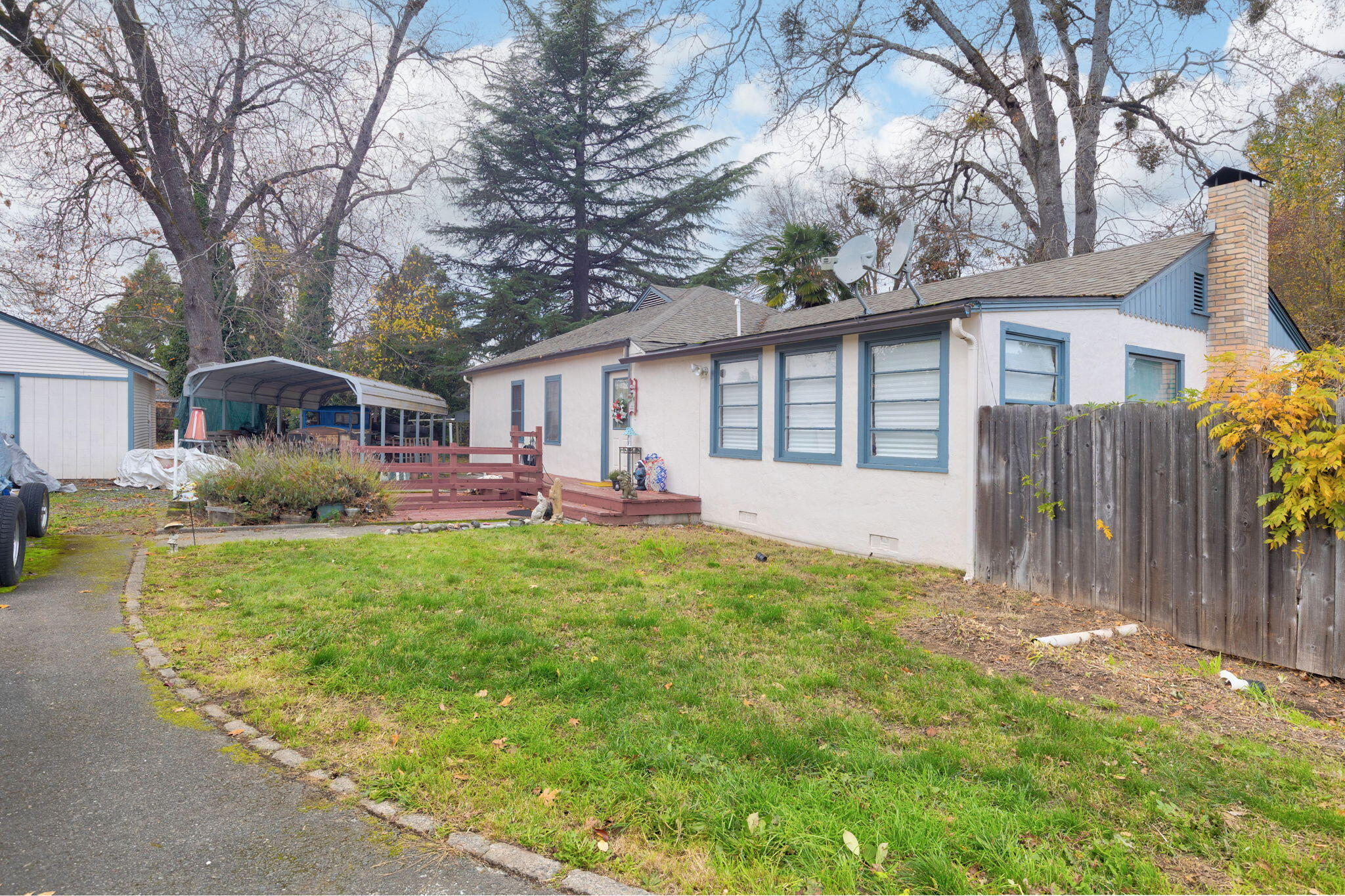 Step into this delightful 4-bedroom, 2-bath home filled with vintage charm and modern versatility. Enjoy cozy evenings by the classic wood-burning fireplace or make the most of the finished basement with exterior access—perfect for guests, hobbies, or extra storage. The spacious 0.47-acre lot features mature shade trees and multiple sheds, offering both beauty and function. Ideally located near shopping, dining, and scenic Baker Park on the Rogue River. Zoned R2, with exciting potential for a detached second dwelling. A rare chance to own a timeless Grants Pass treasure with endless possibilities!