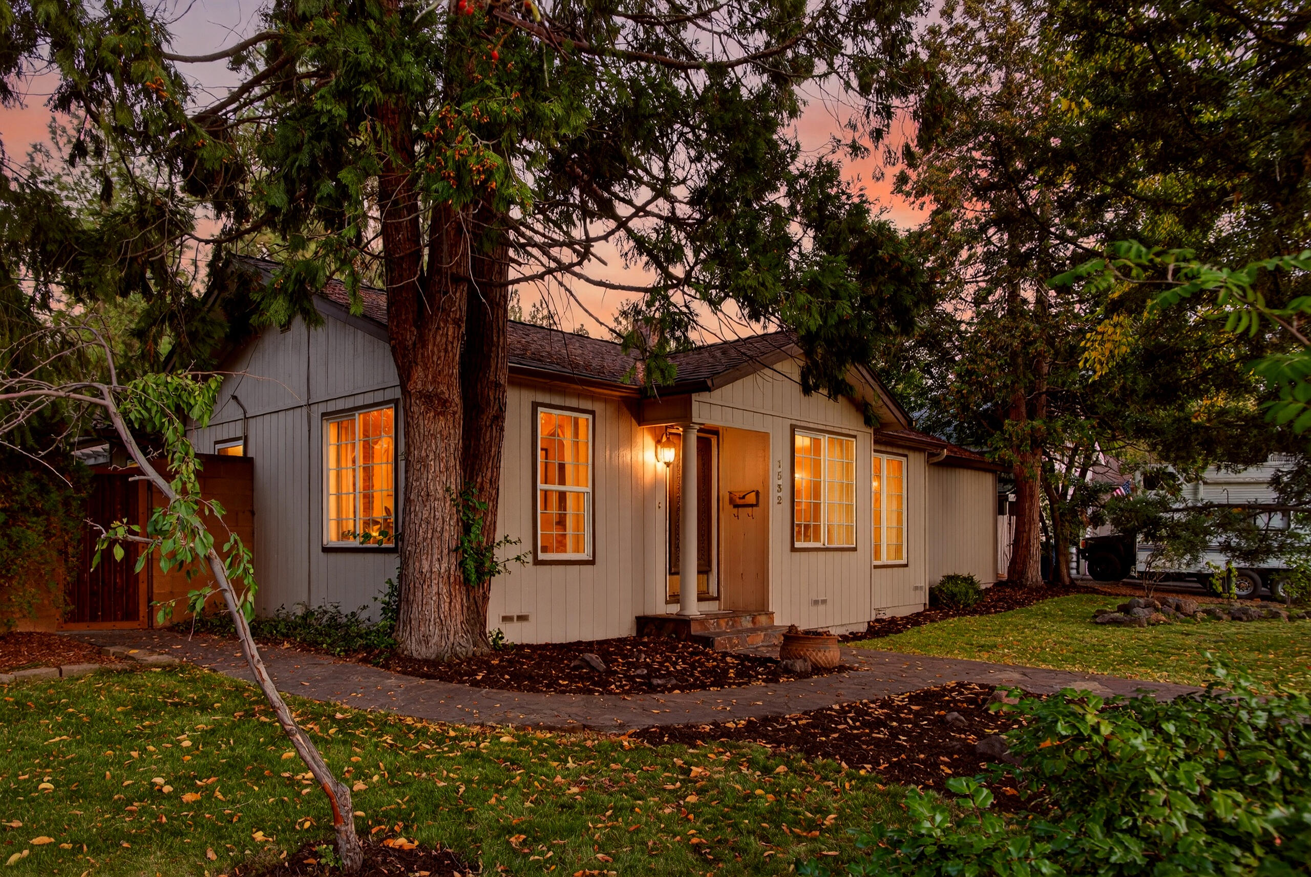 Prime Midtown location! Remodeled, updated and private, this is the retreat you have been looking for. Not only is this a large ¼ acre corner lot, but there is also a 6-car garage with a driveway long enough to fit an RV. Forfeit the electric bill with the 19 owned solar panels! 
There is a beautiful block wall surrounding the yard with custom gates to access the spacious courtyard ready for your personal touches. Living space feels larger in this L shaped single level home featuring a huge great room with built-in bookshelves, vaulted ceilings & travertine stone gas fireplace. The kitchen is a chef's delight along with soft close drawers/cabinets, refrigerator and dishwasher being less than a year old along with an abundance of storage. Water heater is tankless and the washer/dryer is less than 2 years old. The wood floors were refinished in 2021, there are so many unique qualities to this lovingly cared for home you really need to see it for yourself while you have the chance to.