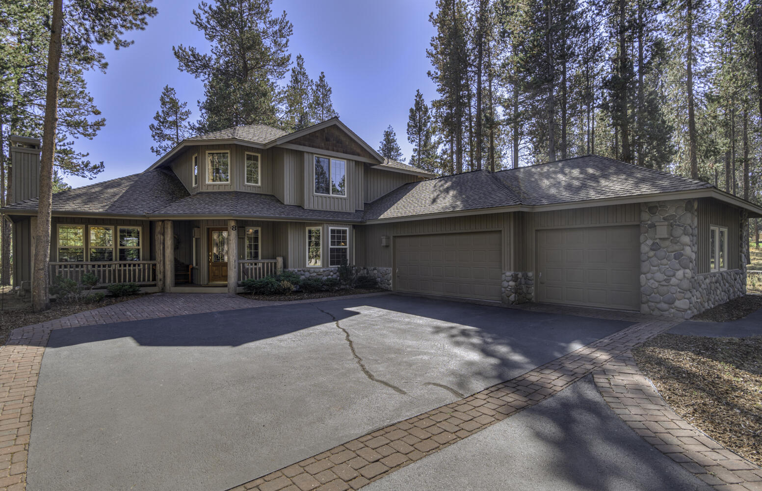 This Charming Lodge-style home has character from the moment you drive up.  Lots of natural light pours in the large windows.  The vaulted primary suite and the fifth bedroom are on the main level.  Upstairs includes a Junior Suite, two more bedrooms. Two bathrooms up. Spacious Deck with morning sun and gas hook up for bbq.  LARGE three-car garage.  Only 8 homes on this lane across from the Woodlands Golf Course.    Landscaping has drip system front and back.  Never rented.  One owner. Ask your Realtor for a copy of walk-through video on youtube.