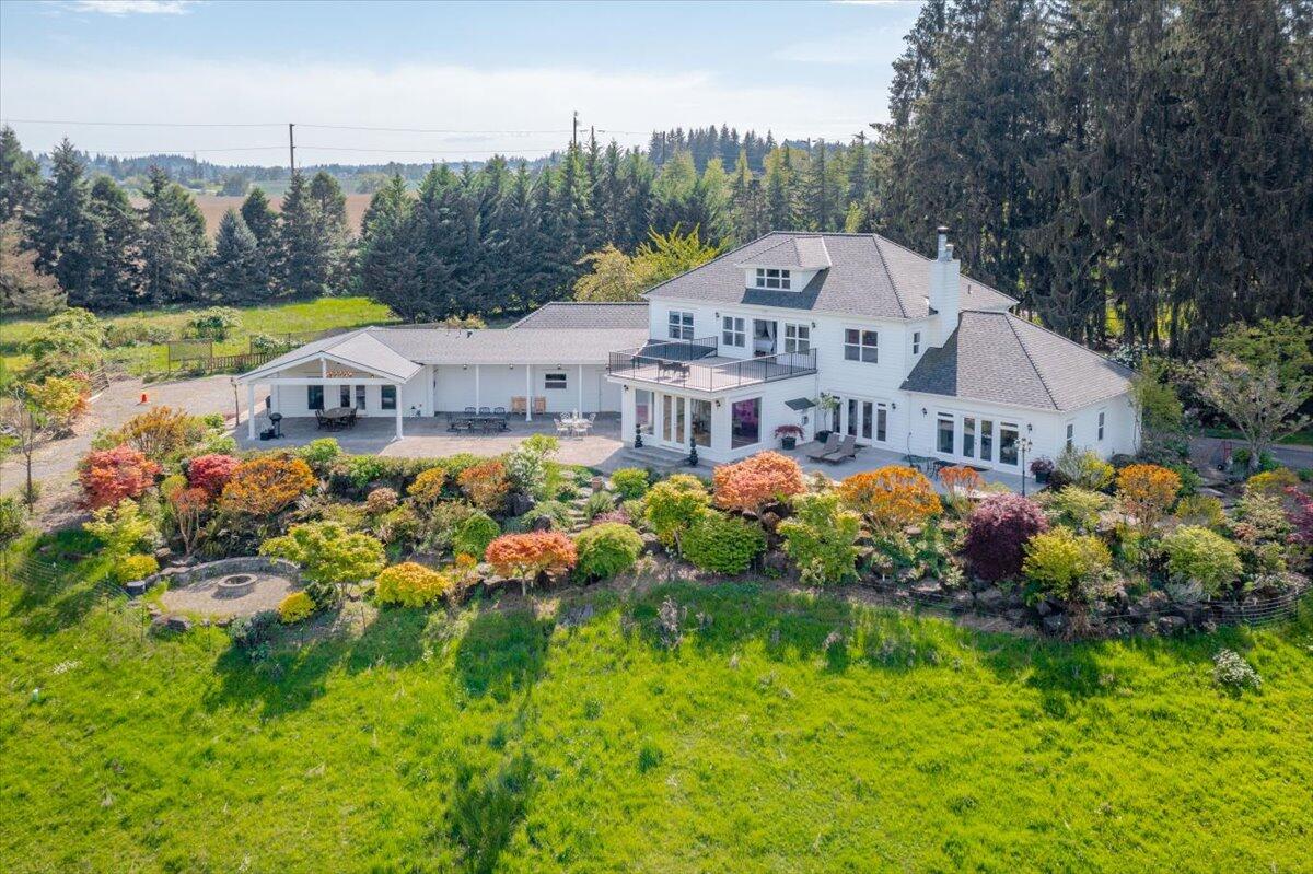 Rare Riverfront Property - Welcome to River Cove Farm! Nestled in the heart of Willamette Valley wine country & just minutes from downtown Salem, this one-of-a-kind estate offers a rare blend of lush acreage, Willamette River frontage, & breathtaking views. A gated entry opens to a long, paved driveway leading to this gorgeous Georgian-style home, which exudes elegance throughout. Spanning 19.05 acres, the property also has a cottage, barn, pastures, fruit trees, private beach & cove!  The main level primary suite features a cozy fireplace and ensuite bathroom, ensuring comfort and luxury. A library with built-ins and a majestic living room provide stunning views. The elegant kitchen and formal dining room are perfect for hosting memorable gatherings. The expansive game/recreation room includes a kitchenette and full bathroom, ideal for entertaining guests.  Enjoy the tranquility of the Willamette River frontage, complete with a private beach and a cove for boat tie-up.