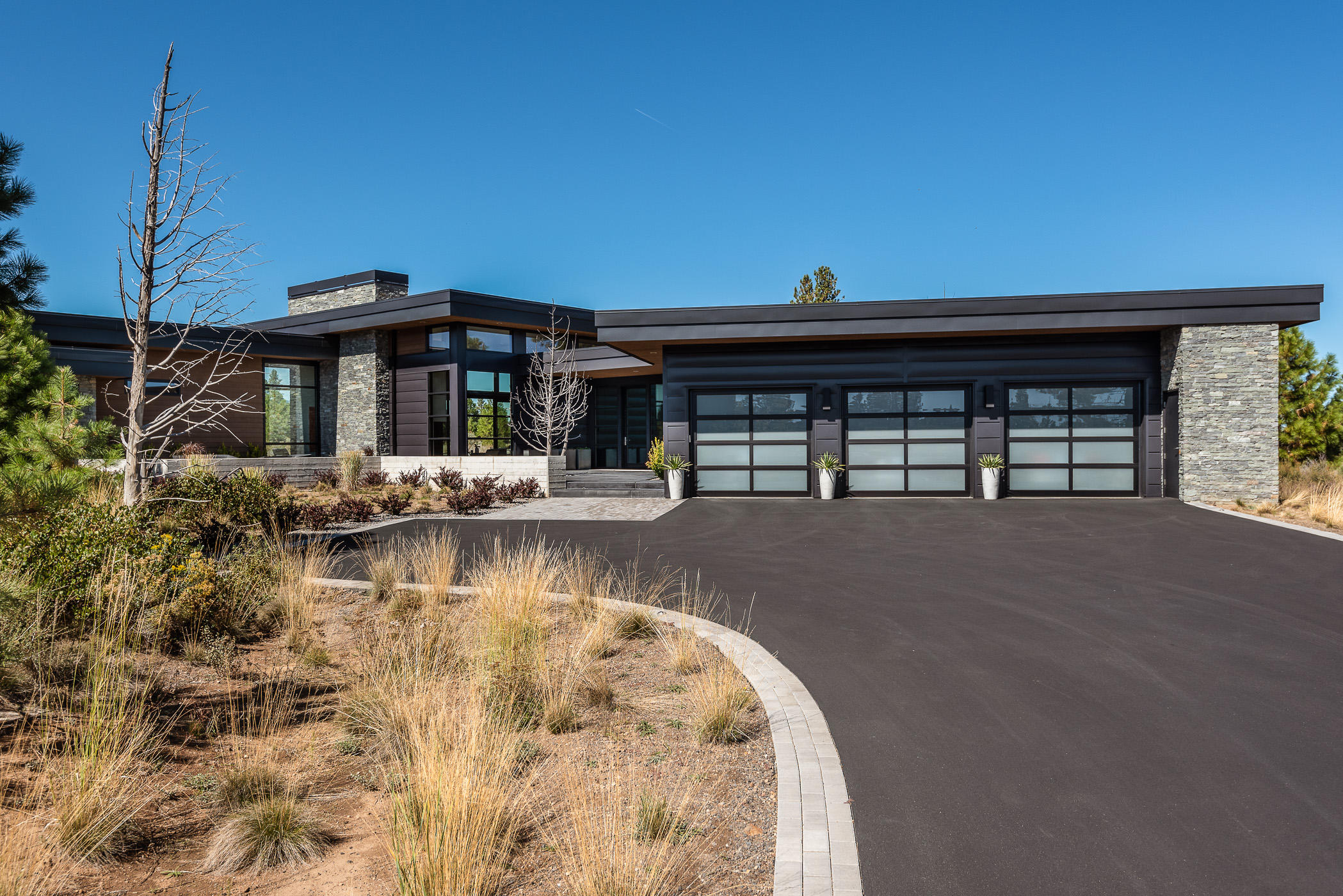 Located in Tetherow, one of Bend's most desirable golf communities, on the way to Mt Bachelor. Incredible High Timber custom home backs to National Forest and offers beauty and privacy that is unmatched and cannot be found anywhere else. Every finish and detail was carefully chosen and the results make this home irreplaceable. Single level living at it's best with floor to ceiling windows and views from every room. The great room has a stunning fireplace feature wall with views that take your breath away as you look out towards your private 25 yard lap pool, hot tub and surrounding forest. This well thought out kitchen is a chef's dream with gorgeous finishes and a very functional layout. The large master retreat is a true oasis. Two full guest suites and an office with patio access. The indoor living area leads seamlessly to the back patio with built in BBQ and outdoor kitchen. An oversized 3 car garage with self contained 4th bay can be for gear storage, a work out room or studio.