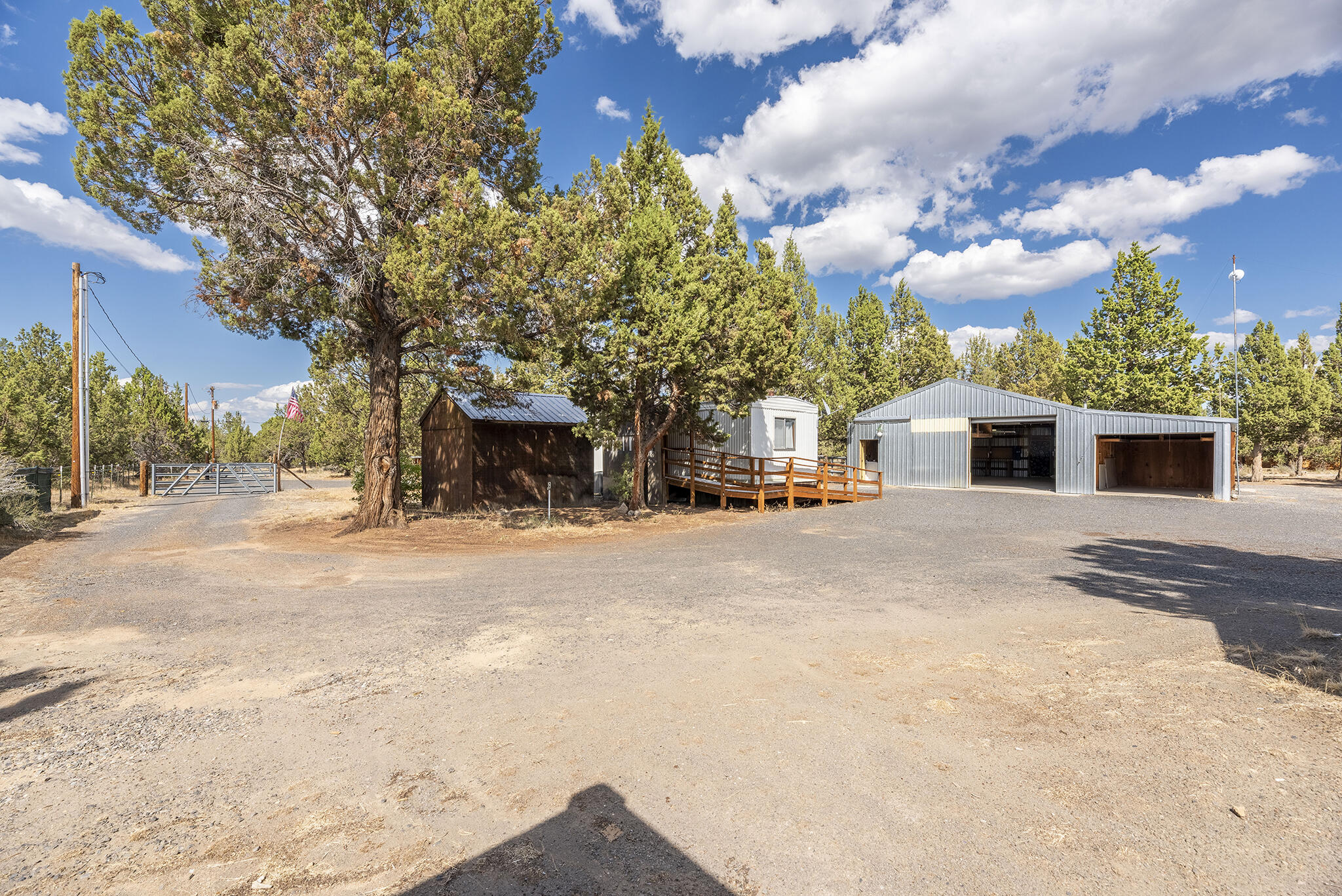 Charming, older 768 sq ft, 3 bedroom, 1 bath manufactured on 1 fully fenced acre. This cozy home features new flooring and thermal windows, wheelchair accessible, and includes an enclosed front porch. Property features private well, standard septic system and three frost free water spickets. Property also features an impressive 36' x 30' shop with both 110V and 220V power, water, pellet stove, woodstove, washer/dryer, accessible loft and two 9.5' tall overhead doors with openers, two storage sheds, sood storage and more on this property.