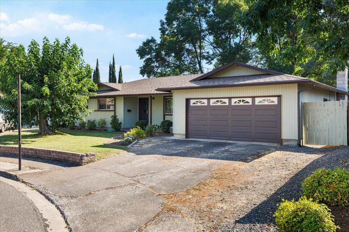 Just around the corner from the high school and a quick stroll to the middle school, this well-loved 3 bed, 2 bath home offers nearly 1,500 sqft of comfortable living space and a floor plan that checks all the boxes—including two spacious living rooms. The interior is clean, thoughtfully maintained, and full of personality, offering a solid foundation for your vision. A few cosmetic updates will go a long way in boosting both value and style. The home features a newer roof and a recently installed A/C system, offering peace of mind and comfort from day one. Out back, the oversized yard is a true highlight—lush, green, shaded, and ready for summer gatherings or quiet mornings under the trees. Whether you're looking for a home to personalize or an investment with strong upside, this Central Point gem is worth a closer look.