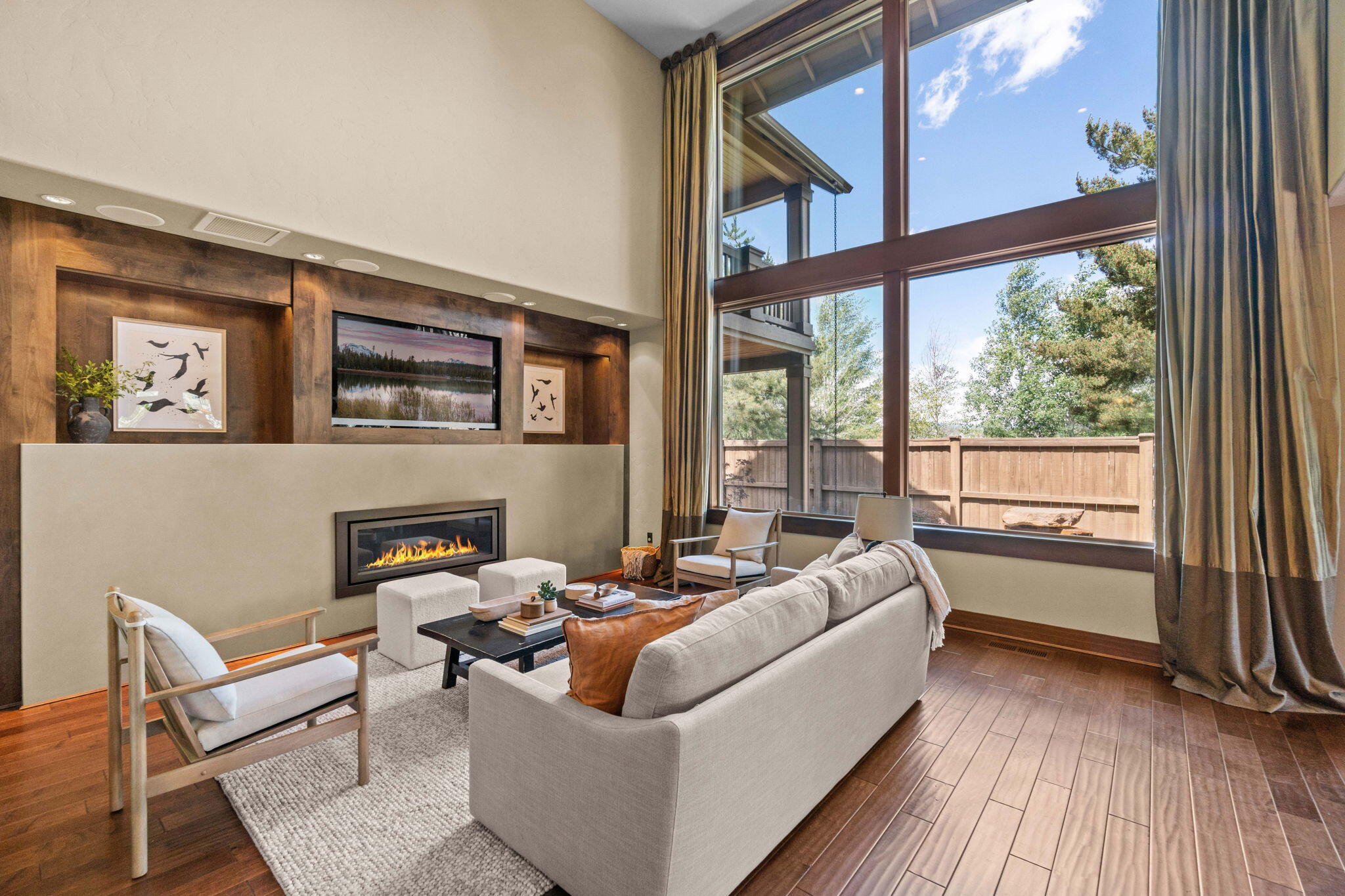 On a quiet cul-de-sac in The Bridges, this stunning home provides a private sanctuary within one of Bend's flourishing SE neighborhoods. Towering windows filter natural light into an open concept main living area with direct access to the fenced back yard, large covered back deck & paver patio with fire pit, perfect for outdoor dining & entertaining. The spacious kitchen is anchored by a large island with ample bar seating & accented with Dacor appliances, soft close cabinetry & walk-in pantry. On the upper level, a luxurious primary suite features a private covered balcony, 2-way gas fireplace & lush bathroom with jetted tub & walk-in shower. Also upstairs, a richly appointed office with a private balcony, additional bedroom & full bath plus a large bonus room. A main level ensuite bedroom & an expansive garage workshop provide additional floor plan flexibility, while the miles of community trails, fitness center, pool & proximity to Alpenglow Park make this an unbeatable location.