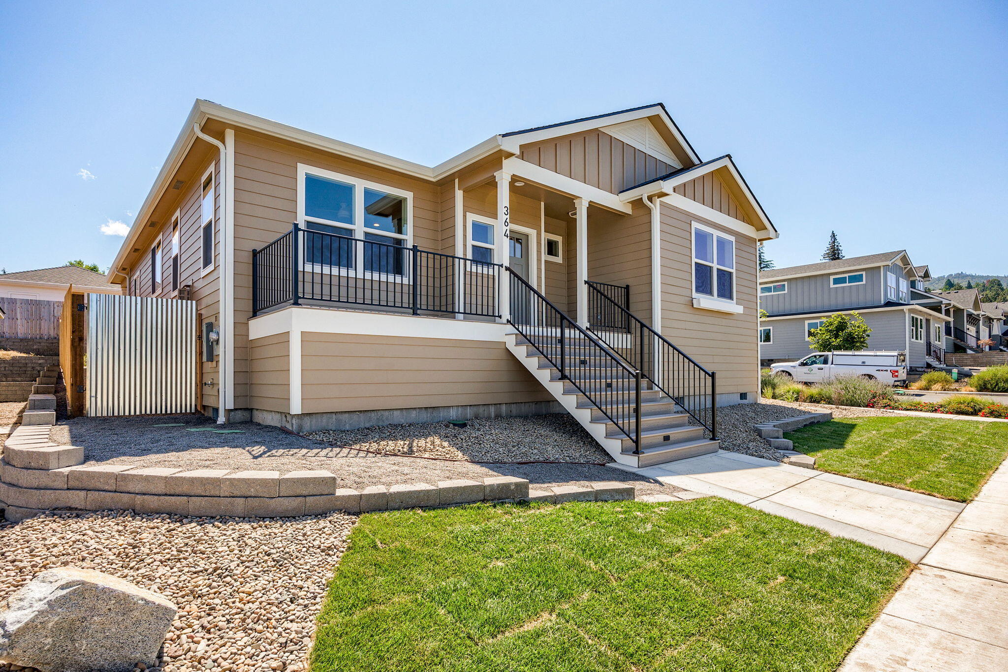 Don't miss this completed single level Taylored Elements Construction home, with great views on a premier corner lot in the West Village subdivision which is just .8 of a mile from downtown Ashland. It's built to Earth Advantage standards with green features and energy efficiency including solar panels, EV charger in the 2 car garage and ductless heating and cooling system. This 3 bedroom, 2 bathroom home has a gas fireplace in the living room, lots of windows for abundant natural light, raised and vaulted ceilings, engineered hardwood floors in main living areas, carpet in bedrooms, tile floors in bathroom and large laundry room, quartz countertops and custom cabinets with soft close drawers. The home has a front deck/porch with great views and back patio with a fully landscaped yard, drip irrigation and side to back yard 6 foot fencing. Make an appointment to view this low maintenance, comfortable home today!