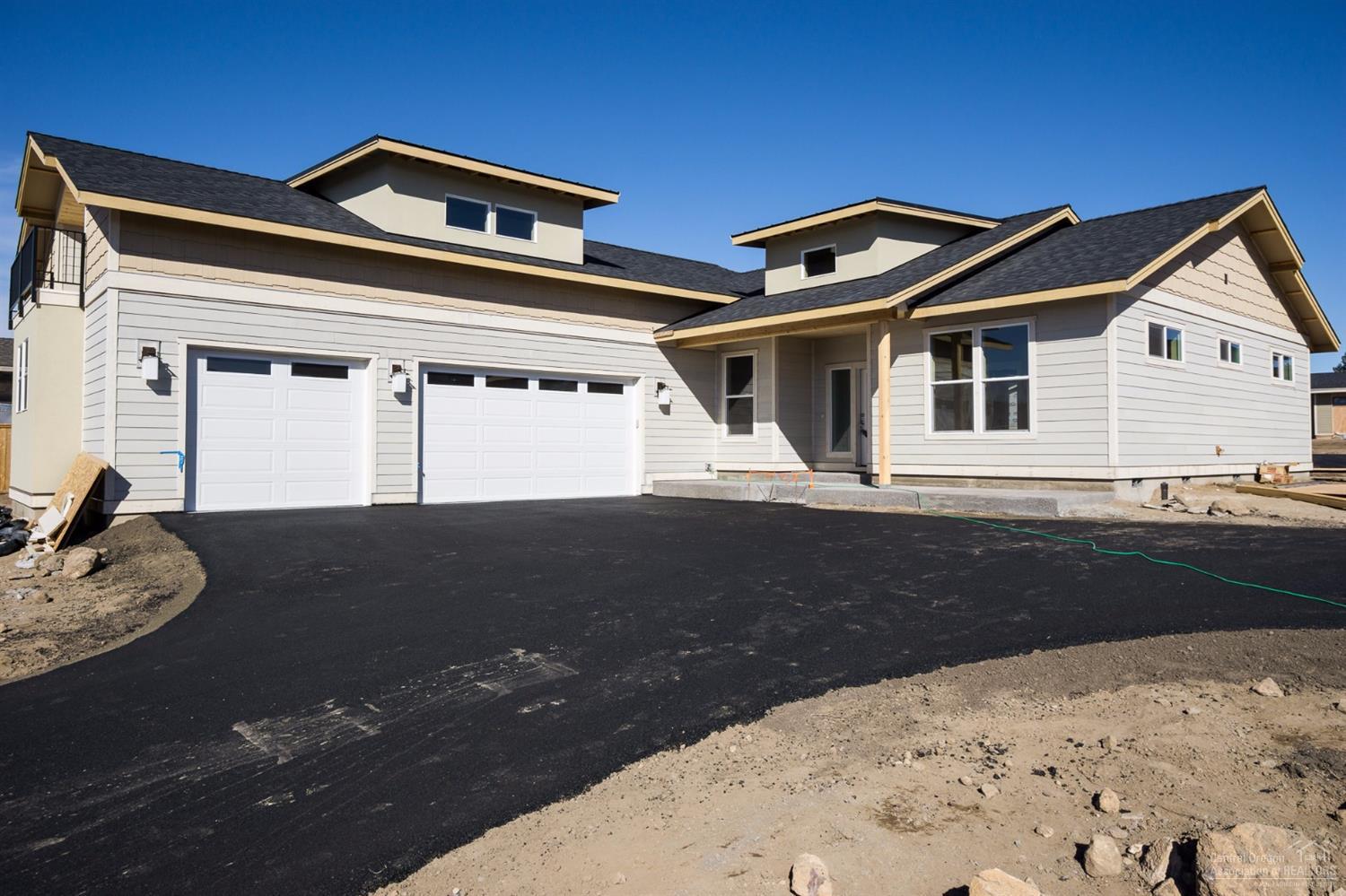 Designed for gracious living, this attractive home by JD Neel Construction Inc. places all rooms on the main level with the exception of a 432-sq ft bonus room and balcony over the three-car garage. The master suite and remaining bedrooms at opposite sides of the home are separated by a spacious great room with island kitchen. A den/office opens from the foyer. The master bath features dual vanity sinks and a large walk-in tile shower. Covered front porch and rear patio. Large lot with room for RV parking.