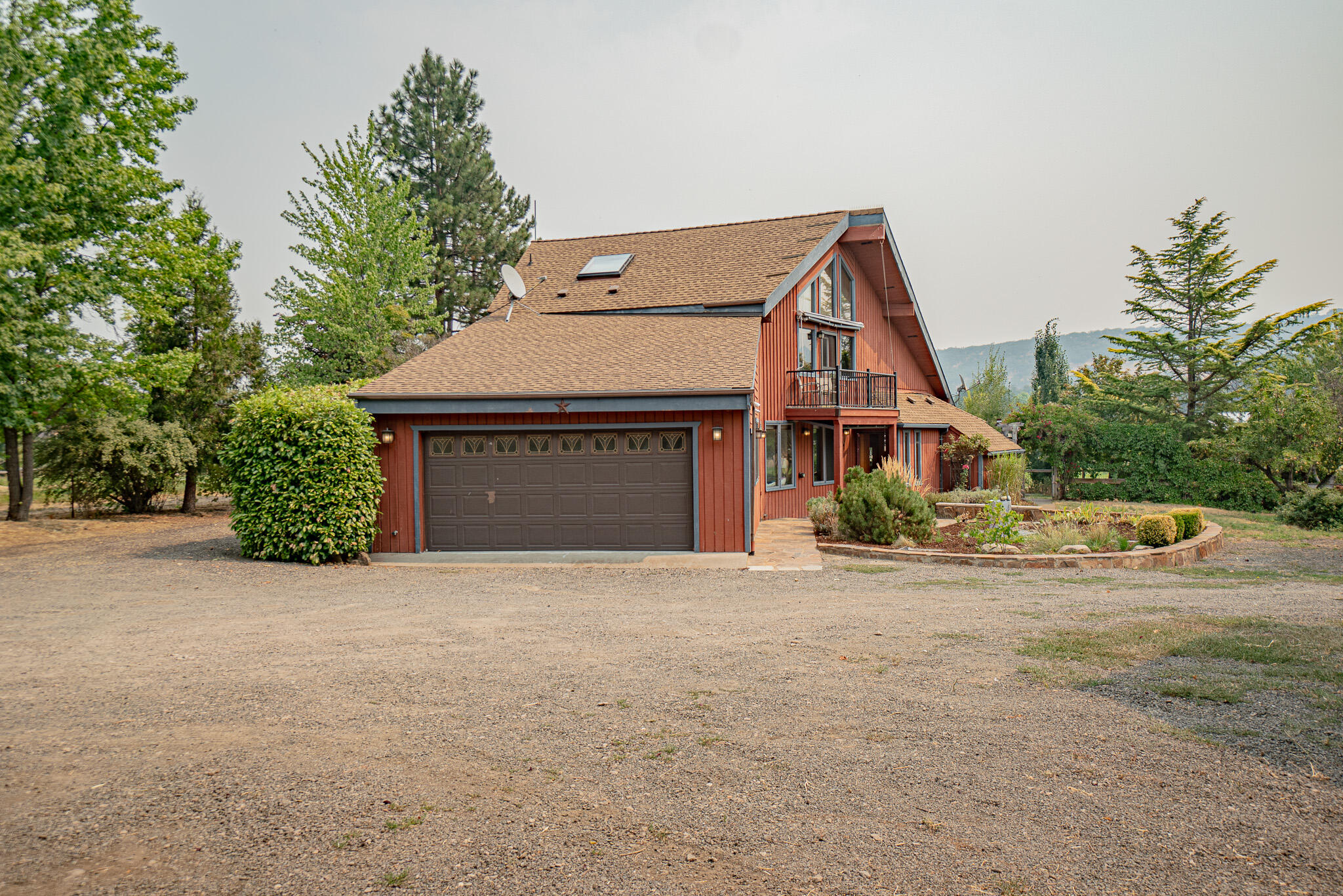 Water rights w/TID, Gorgeous home, Charming shop/barn with full bathroom (looks like an old carriage house), a Pond, huge grassy Pastures, & Views!! In beautiful rural Ashland (minutes to town), & 5.14 acres, What's not to love!
This contemporary home with cedar siding will knock your socks off. The kitchen has been thoughtfully updated with breakfast bar, granite counters, painted cabinets, tons of storage , countertop space, & opens into the Dining & Living room. The custom staircase is a showstopper & is the centerpiece of the open concept living area. Downstairs you will find 2 bedrooms with brand new carpet.(as of 8-24-23) & good sized bathrm. Upstairs is a dream primary suite, with walk in closet, balcony, sitting areas, office space, views, & a en suite bathrm. Home has spacious mudroom/ laundry room with tons of storage & attached 2 car garage. Outside you will find more living space with an oversized deck with views of your huge backyard, pasture, mature trees & landscape.