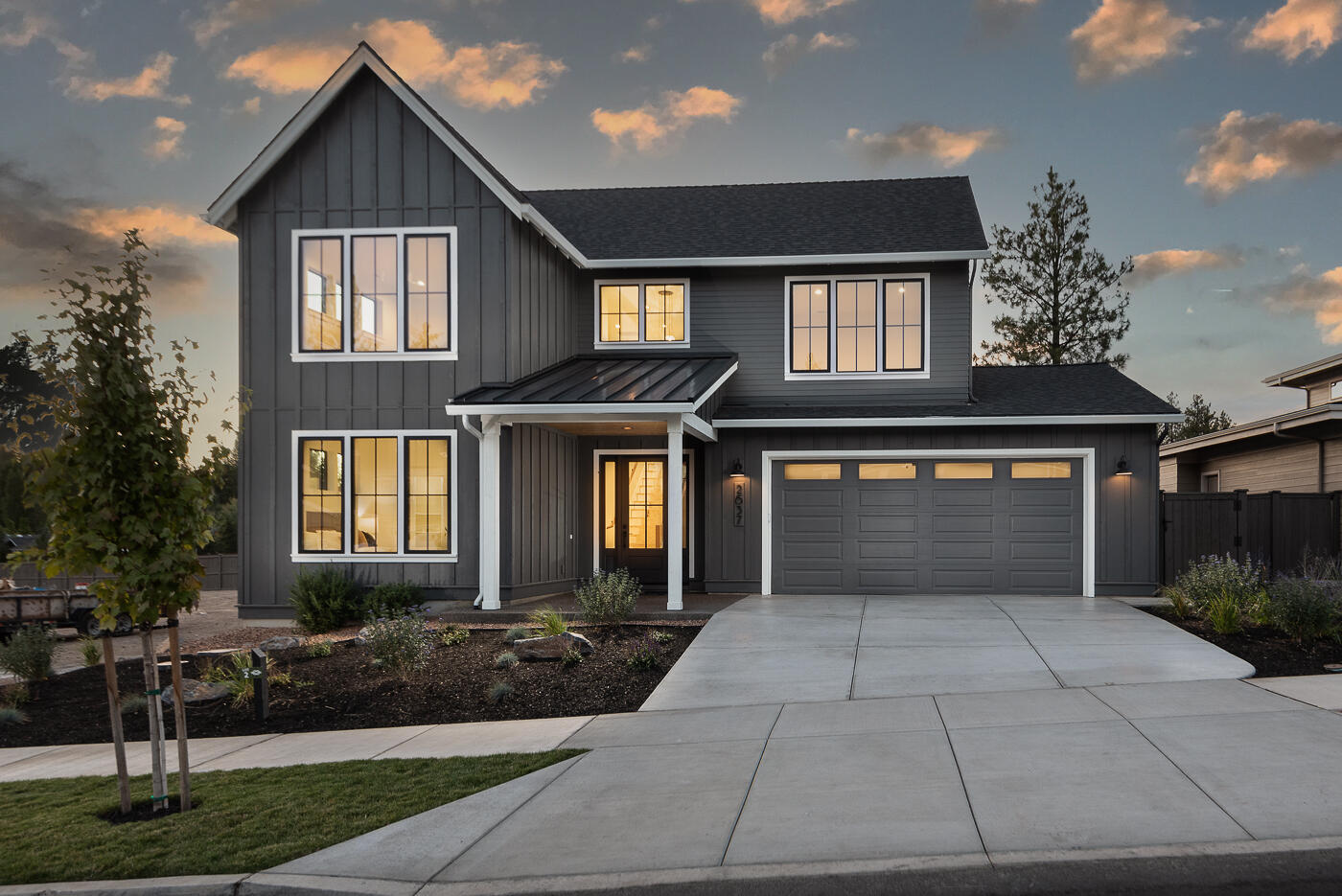 Enjoy a $15,000 builder incentive—use it toward custom upgrades, closing costs, or a rate buy-down to make this home truly yours! American Farmhouse by Structure Development NW, nestled in NW Bend's newest community, Talline. Home seamlessly blends contemporary comforts with timeless farmhouse allure. Exterior showcases a traditional farmhouse silhouette, complete with a gabled roof, board and batten siding, and a welcoming front porch. Large windows illuminate the interior with natural light, highlighting the high ceilings, hardwood floors, and open floor plan designed for modern living. The kitchen is a focal point, featuring high-end appliances, quartz countertops, and a spacious island and dining area. Spacious great room centered around a cozy fireplace. Primary suite on the main level, with a tile shower, and a large walk-in closet. Guest bedroom, mudroom, and laundry also located on the main level. Upstairs offers two additional bedrooms, full bathroom, and bonus room.