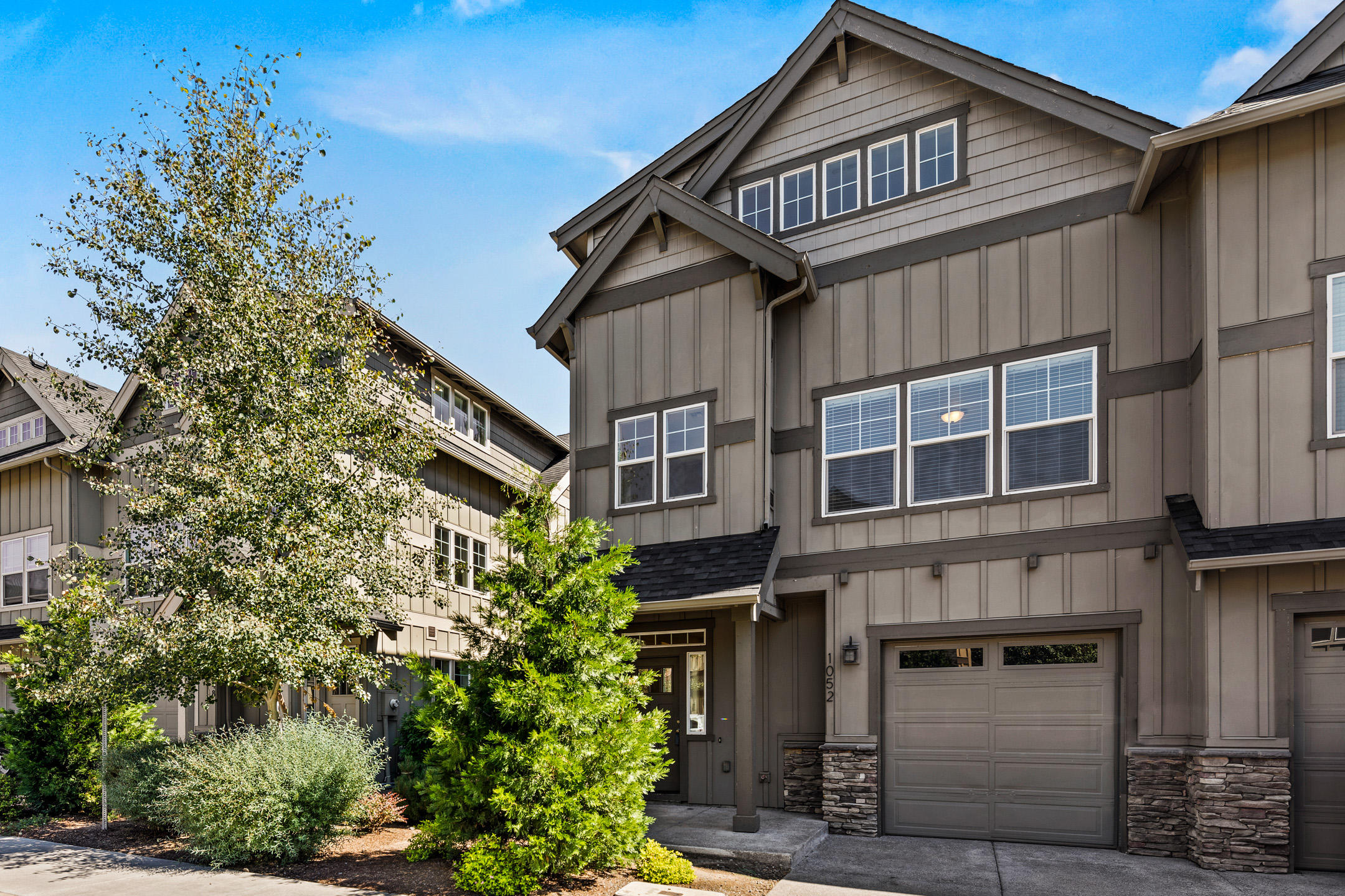 Unlock the door to easy living!  Dynamic townhome offers exceptional finishes that blend style and durability, including laminate flooring on the main level, painted cabinetry, & slab granite counters. You'll appreciate the romance of a gas fireplace and the comfort of central air conditioning. Gourmet kitchen provides the perfect backdrop for your culinary creations while the patio and fenced yard provide the perfect outdoor setting for your enjoyment. Brighten laundry day in the sunny laundry room featuring wraparound windows and a granite folding counter. Escape to the sanctuary of your own suite ready to pamper with dual sinks, tile flooring, & enormous walk-in closet. When you rise to the third floor, envision the limitless possibilities of the large bonus room! Additional convenience can be found in the attached garage with room for your Bend toys. Ease of access to Farewell Bend Park, Old Mill District, and more, make this home your key to the good life!