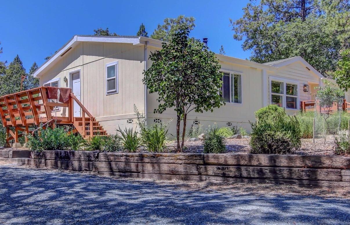 You won't want to miss this well-maintained, manufactured home on over an acre! Located in a quiet rural neighborhood just minutes from Grants Pass, this home has 3 bedrooms and 2 full bathrooms. French doors lead you to a den with a built in desk and shelves. There are 2 dining areas off of the kitchen - one for casual dining and another for more formal occasions. Outside you will find a large carport with cement floors that will fit 2 cars or provide lots of storage. There is even more storage space or room for small animals in the chicken coop. There is a shaded meadow area that will be enjoyed by you or your guests. Call today! This home won't be on the market long!