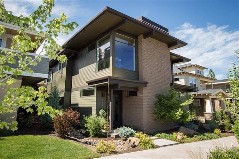 Beautiful contemporary home in NorthWest Crossing features reverse living plan w/ direct access to main level through 2-car rear alley garage. Front entrance, 2 BRs at sidewalk level below. Bright great room w/ wood floors, gas fireplace. Tile kitchen counters w/ slab island, full tile backsplash, sleek sapele cabinets. Den/office. Master suite on main level w/ large tile shower, dual vanity sinks. Fenced and landscaped yard w/ deck, flagstones, outdoor living areas. Convenient cabinets in laundry room.