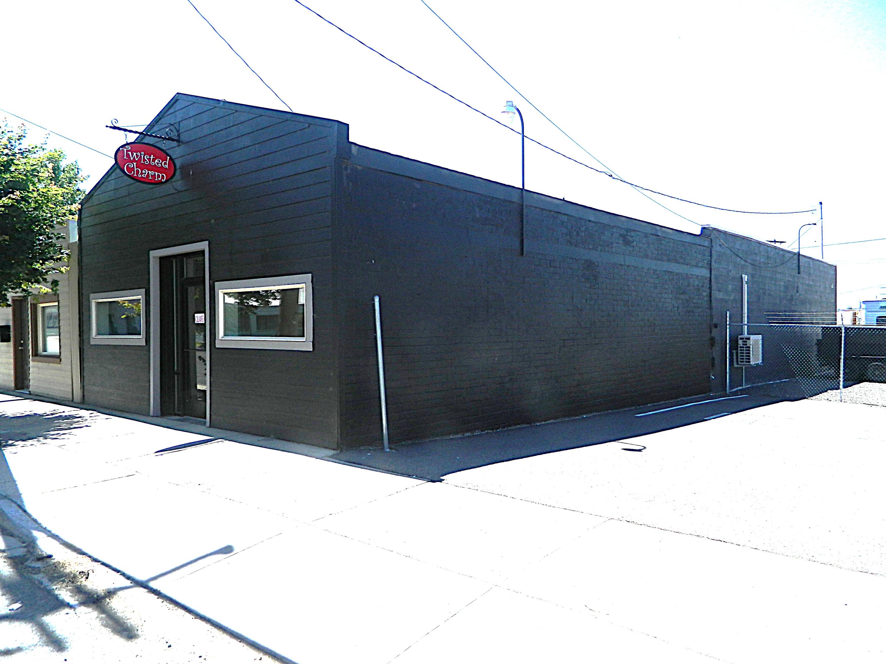 Come check out this well maintained commercial building. This building has a variety way of uses. It can be a small retail store with a warehouse storage in the back. It can be cleared out and used as a contractors secured building with a ramp in the back so you can pull vehicles in it. Could split it up with a few offices in it. There is a separate a parking lot with a security fence next to the building included in the sale.   Come bring your imagination and make this your own