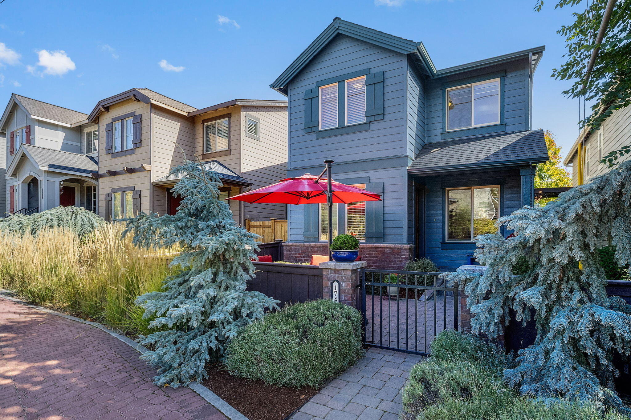 Discover a home full of charm and convenience just minutes from downtown Bend with easy access to the river trail. Step inside to find hardwood floors, stainless steel appliances, and elegant granite and tile countertops. All bedrooms are located upstairs along with a versatile bonus loft, perfect for a home office, playroom, or media space. Unique to this home, enjoy not one but two outdoor living areas—including a spacious, fully enclosed front courtyard designed for private entertaining. The fenced yard with a zero lot line offers both security and low-maintenance living. Outside the fence, landscaping and snow removal are included, making this an easy-to-care-for option that works beautifully as a starter home, second home, or simply a place to enjoy Bend living with less upkeep. With its combination of style, location, and thoughtful amenities, this home is a rare find that blends comfort, functionality, and Bend's best lifestyle right at your doorstep.