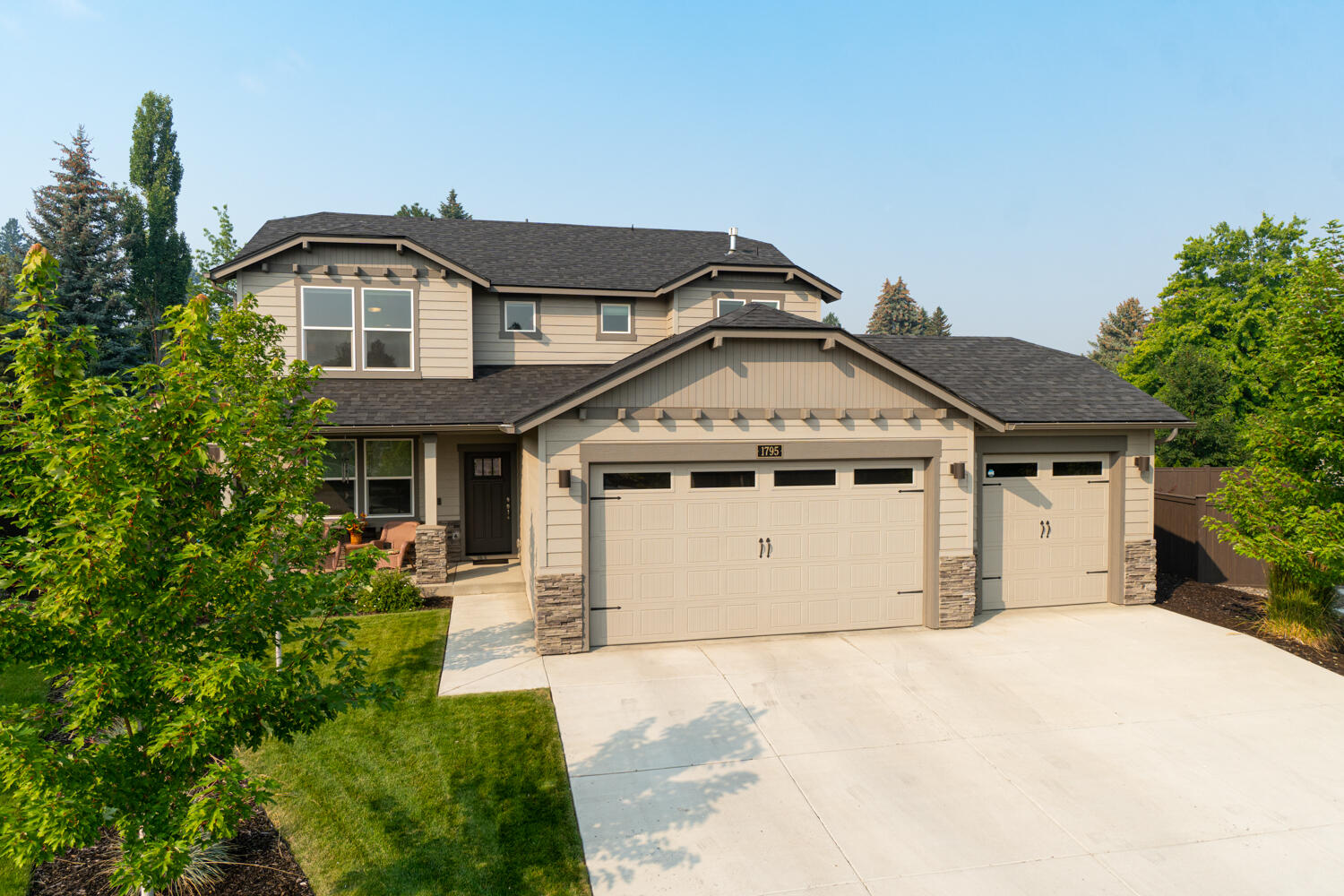Immaculate home nestled in desirable NE Bend. Covered front porch leads to an open concept living w/engineered hardwood throughout the lower level, top down cellular blinds, quartz throughout & carpet upstairs. Main living area ftrs a cozy gas burning fp & convenient built-in work station. Kitchen has quartz counters, full height backsplash, large central island, stainless steel appliances, huge pantry, under cabinet lighting & soft close white cabinetry. Large eating area w/sliding doors that lead out back onto the patio. Primary bedroom boasts a spacious walk-in closet & bath ftring double vanities, enclosed toilet area, large soaking tub & tiled shower. Two other bedrooms share a full bath + a 4th bedroom off the entry w/French doors. Oversized laundry room w/built-ins. Expansive outdoor living space w/custom pergola complete w/shade screens & gas bbq hookup. 3 car garage, gas H2O water heater, A/C, Ring alarm system +more. Close to hospital, Pilot Butte & other East-Side amenities.