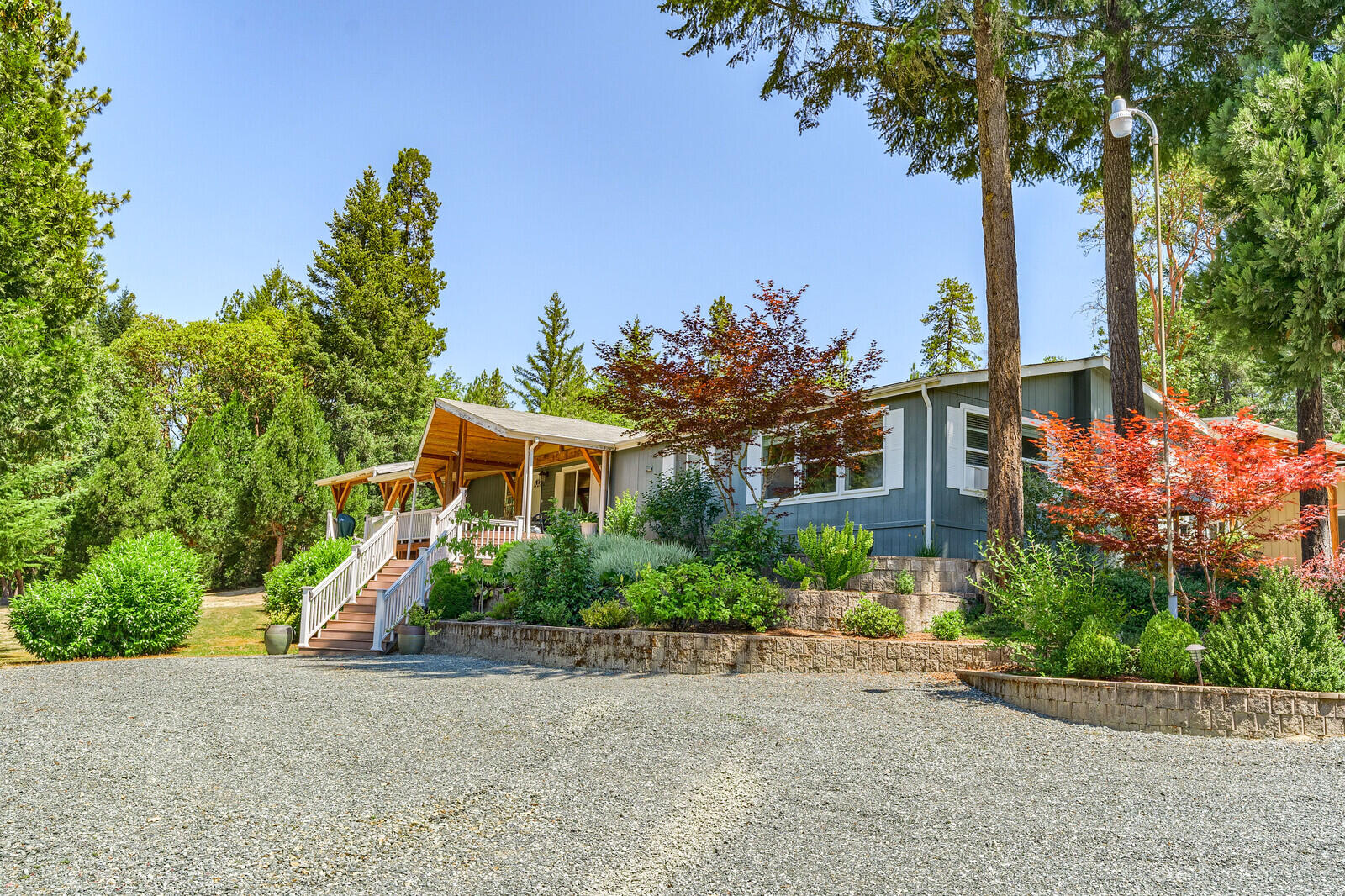 Live the Oregon Dream in the country on this 5.14 acre lot with lovely 2 bed (plus an office),  2 full bath manuf home with an attached, stick framed guest apartment (1 bed, 1 bath), for a total of 3045 sq ft. .  Perfect for guests or in-laws. Main home features vaulted ceilings, split floor plan, large kitchen with lsland, an abundance of windows, formal dining room and huge master suite.  Entertain on the enormous covered deck that overlooks the neighbor's pond and the gently rolling land. Exterior feat also include 2 car garage plus workshop area, carport, a few equipment sheds, fabulous fenced garden area and plenty of room to roam.  Finish the gorgeous water feature that has been started, that will cascade down the slope.  The property has a lovely creek that runs through.  Is this YOUR NEW HOME?