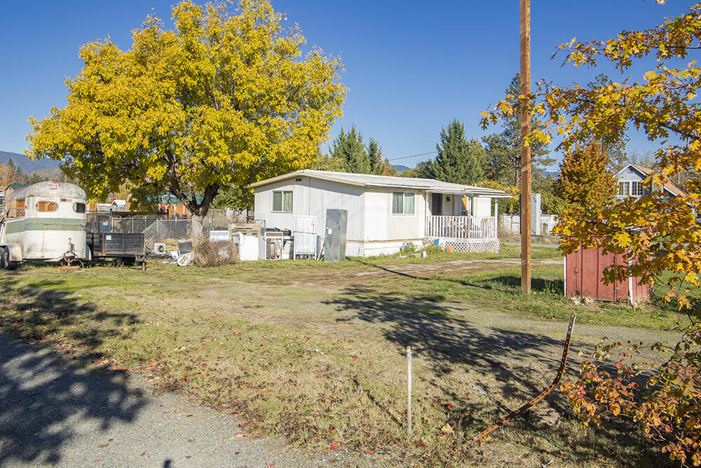 2 Bed, 1 Bath Double-Wide Manufactured Home on almost a Half Acre of Land in the Redwood Area! The Home has Extensive Interior Remodel & Upgrades, inclusive of High-Quality Laminate Flooring throughout, a New Bathroom, New Kitchen Cabinetry & Appliances, New Electrical including 200 Amp Panel, Water Heater, & a Brand New Well Pump! The Home needs Kitchen Counters installed (Estimate in hand for $1,100), & some additional Minor Finishes completed, but is Livable as-is. Excellent Parking Options here, with the Attached Carport, & RV Parking with Full Hook-ups! Nice Storage Shed Included. Enjoy Level Useable Land, with plenty of room for Kiddos & Animals. PLUS, Zoning is such that this Property can possibly be divided into Three Parcels! Recent Survey on File provides Accurate Boundaries & Corners. Pretty Mountain Views & within Walking Distance of Parks & the Rogue River! Seller will include Personal Property Items to be utilized to Complete the Minor Finish items this Home still needs.