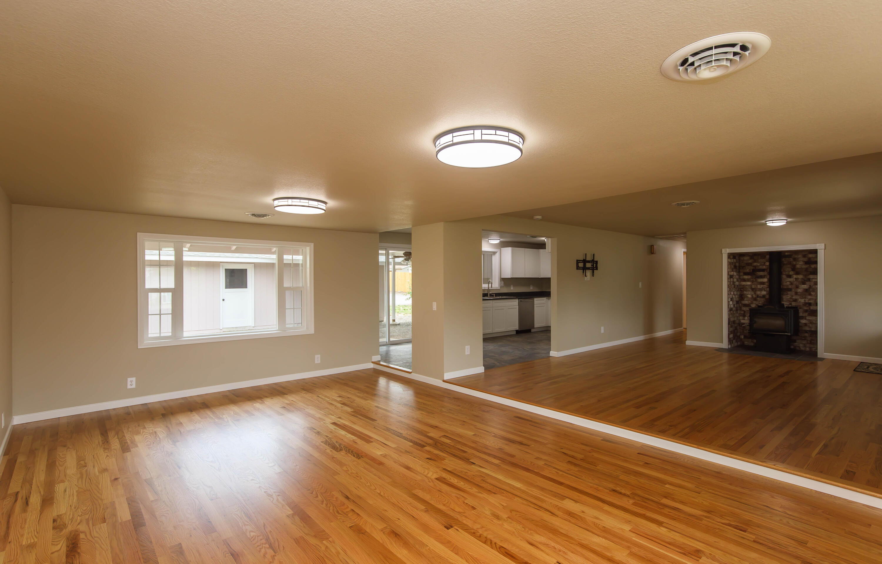 This Medford home is designed for the way you live, comfortable, flexible, & full of spaces to enjoy. With 3 bedrooms plus an office & 2 baths, everyone has room to spread out. The new kitchen sports tile floors, granite counters, cabinets, & stainless appliances. Gather in the living room around the wood stove, with hardwood floors & a generous addition that expands your options for entertaining or relaxing. At day's end, retreat to the primary suite with its vaulted ceilings, cozy gas fireplace, & doors leading out to a covered courtyard; the perfect spot for morning coffee or evenings outdoors. Outside, the 720 sq. ft. shop with double garage doors is ready for projects, storage, or toys. This .35-acre lot has space for multiple RVs, fenced yard, garden, dog run, & sprinkler system. Strong bones, Milgard windows, 2x6 walls, & updated insulation mean this home feels as solid as it does inviting. Near schools, the park & bike path. A place where life can flow naturally, indoors & out