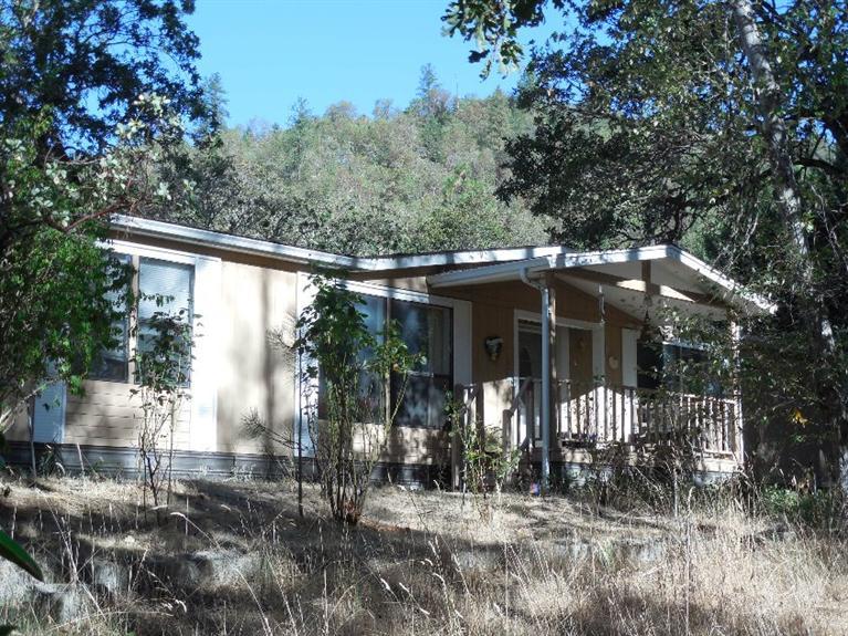Great private rural property at the end of a county road, backed by 80 acres of BLM land and is adjacent to the back side of Pacifica. This 1.4 acres has a nice mix of mature trees that nestle this property. With a little love this could be a your next destination; the home offers 1957 sq/ft, 3 bedrooms, 2 bath, large master bedroom with two walk-in closets, a cozy living room with a gas fire place, large open kitchen - dinning area and detached 24x24 garage with breeze way. Property has many large flat areas for; animals, gardening, children to play or what ever you may want. Owner is motivated.
