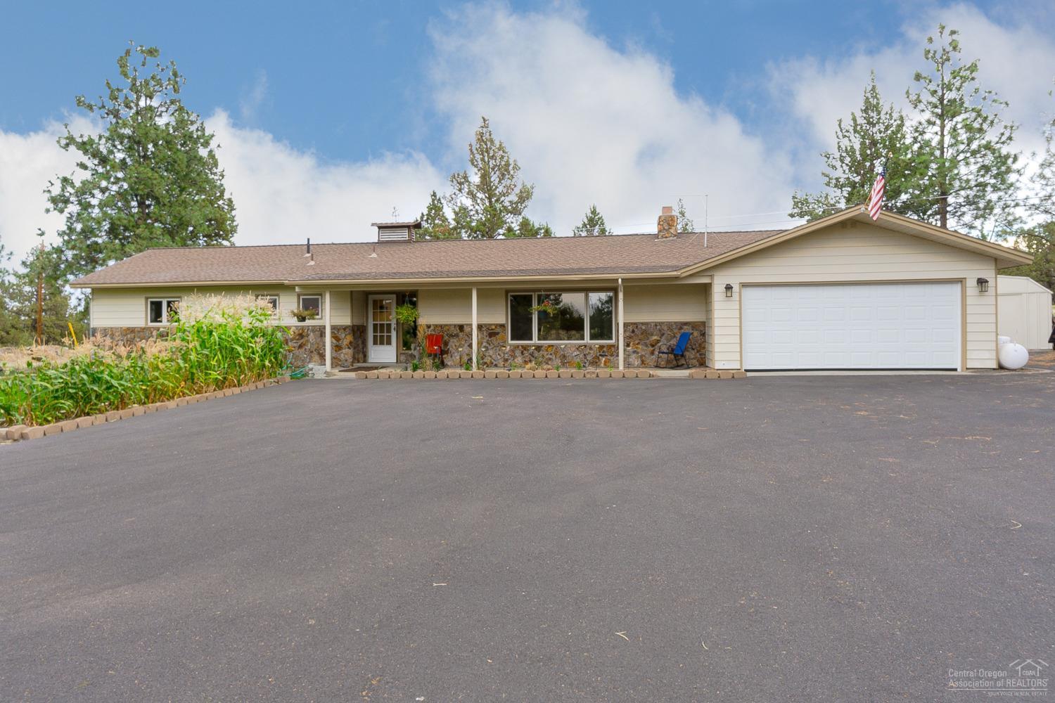 Updated ranch style home on the edge of Eagle Crest on 2 acres. Updated finishes include solid wood floors, professional grade appliances, dbl oven and granite counters. Open floor plan with oversized master w/soaker tub and walk-in closet. 3rd room could be an office or additional bedroom. Plenty of room for your toys with the 20X24 covered RV area, several outbuildings, paved driveway and dbl attached garage. MUST SEE!