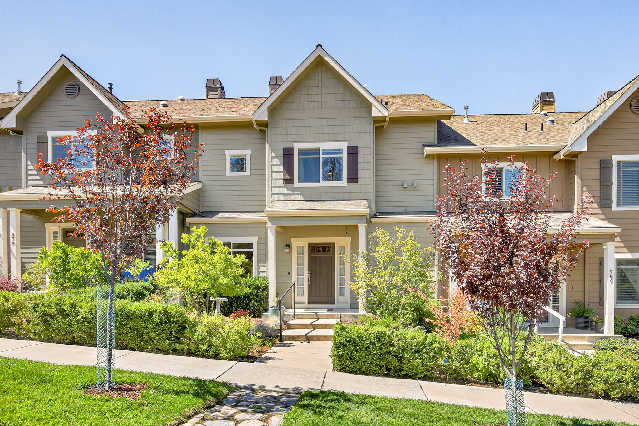 Generous 2,201 sq ft townhome with sweeping Siskiyou mountain views and inviting outdoor spaces. A bright bonus room at the entry is ideal for an office, library, or media retreat. The open living area features bamboo flooring, a gas fireplace, and a kitchen with a gas range and ample storage. Dining flows to a covered deck perfect for entertaining or sunsets. Upstairs, the primary suite offers vaulted ceilings, a walk-in closet, balcony, and ensuite bath with soaking tub, tile shower, and dual vanity. Two additional bedrooms and a full bath complete the level. The oversized two-car garage provides excellent storage or workshop space. An elevator shaft is preinstalled on all three levels and currently used for storage, offering future potential for true age-in-place living. Set in a quiet location between Kestrel Park and North Mountain Park, this thoughtfully designed home is the perfect base for enjoying the mountains, sunsets, and all Ashland has to offer.