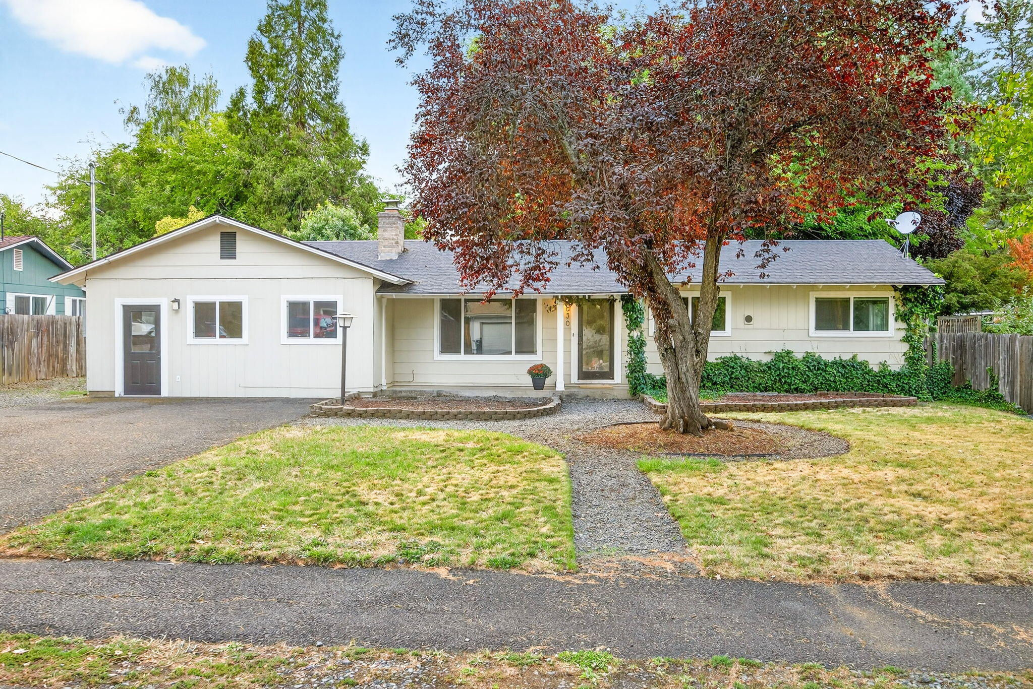 Sweet single-level ranch in a quiet Jacksonville neighborhood. Sitting on a .24-acre lot, this three-bedroom, two-bathroom home offers both flexibility and potential. The layout includes a spacious living room and a dedicated office, perfect for a work-from-home setup. A sliding glass door off the dining area opens to the expansive backyard, where mature trees provide shade and privacy, and there's plenty of room for gardening or outdoor entertaining. The kitchen features wood cabinets and a breakfast nook that's ideal for casual meals or hosting friends. The three bedrooms are thoughtfully separated from the main living spaces, creating a sense of retreat. A bonus room in the converted garage provides extra versatility—use it as an art studio, exercise room, or media space. Additional highlights include RV/boat parking and close proximity to the elementary school and charming downtown Jacksonville. This property truly combines convenience, comfort, and opportunity.
