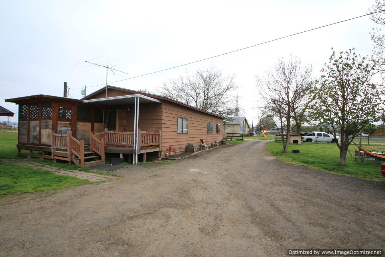 2 flat usable acres fully fenced with shop. Country feel yet city close, with good well, Irrigation from Rogue River Irrigation District and city sewer.