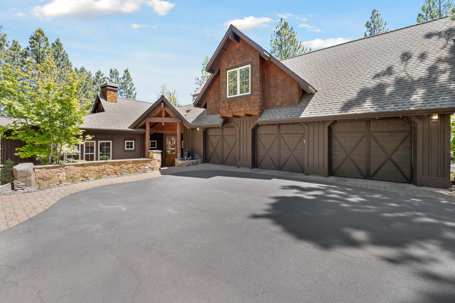 Experience an extraordinary fusion of NW contemporary and rustic lodge style in this stunningly and meticulously designed custom home, nestled among the pines overlooking Awbrey Glen's iconic 13th fairway. This home features soaring vaulted ceilings adorned with tasteful wood accents and exposed beams and a massive stone hearth with a wood-burning fireplace creating a dramatic and inviting atmosphere. The chef's kitchen is a culinary dream, equipped with a Wolf Range, double oven, granite countertops, and a large island, making it ideal for entertaining. Main level primary suite is a serene retreat, featuring a gas-burning fireplace and a luxurious master bath with double vanity and a beautifully tiled shower. A generous bonus room and two spacious bedrooms provide ample space for family and guests on the upper level. The peaceful outdoor living area includes a large wrap-around deck and a hot tub, perfect for relaxation. This exceptional property is a rare find and not to be missed.