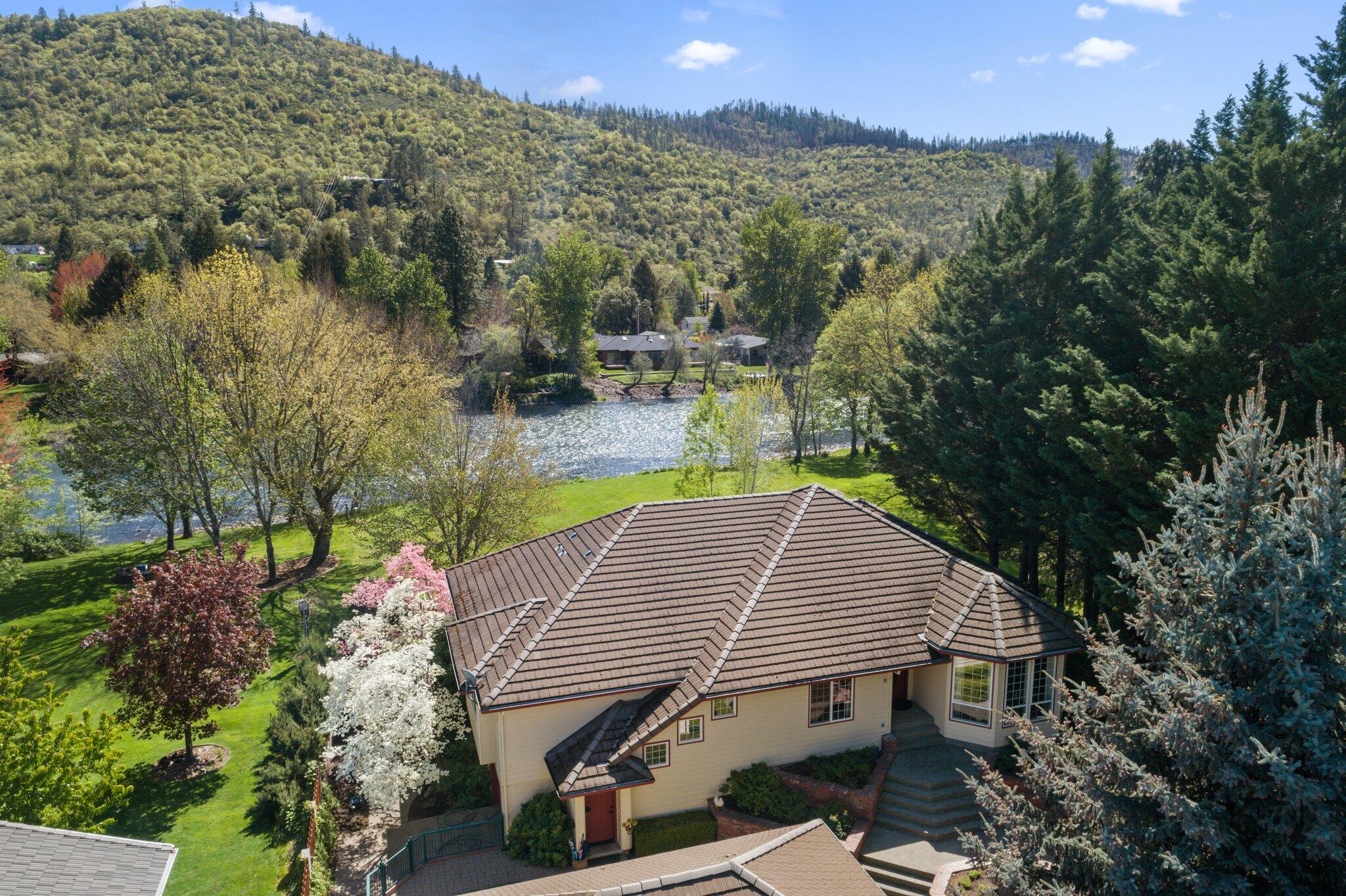 Stunning home with over 100ft of river frontage! DO NOT MISS OUT! The home's main level is 2,870 SqFt and the basement level is 2,800 SqFt! Main level features 3 beds and 2 baths plus an office. The daylight basement features an additional 2 bedrooms,1 bath, a workshop, storage space and even more room for storage or activities. As you enter the home you'll notice the attention to detail and craftsmanship. This home has had extensive remodeling in the last five years, the kitchen has granite countertops, double ovens, and top of the line appliances. The master bedroom features sliding glass doors that lead out to the deck overlooking the river and the luxurious bathroom contains a beautiful marble floor, shower and countertops. The property is immaculately landscaped and feels like a park. Too much to put in a few short sentences! You won't regret coming to take a look at this river property!