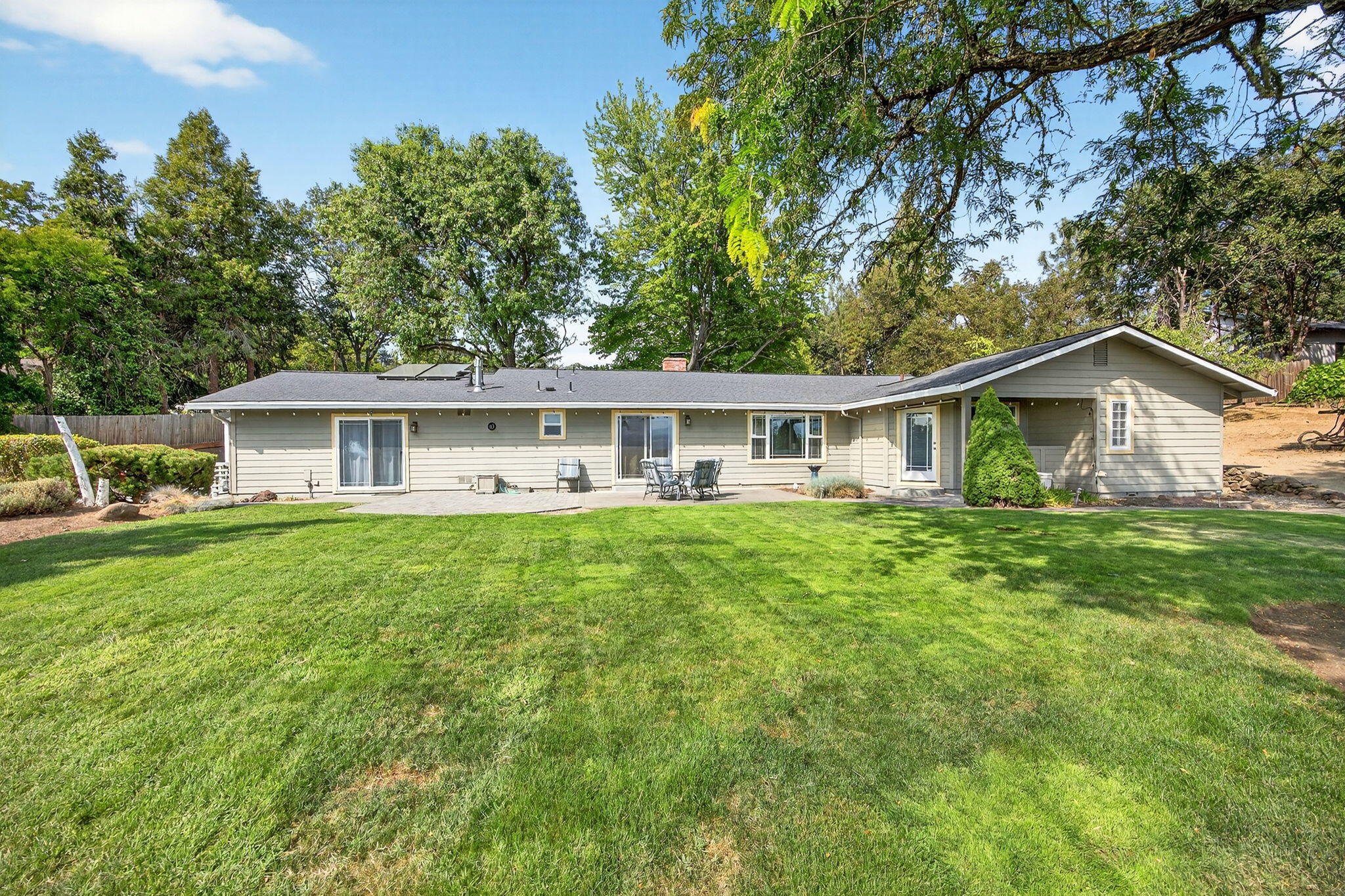 Gorgeous Country Setting with great views and Lots of Privacy. This beautiful, well maintained, 1 story contemporary home has had lots of updating and remodeling. This is a 3-bedroom, 3.0 bath home with approx. (2,323 sq. ft). This home has a composition shingle roof, Hardi-plank siding, vinyl clad windows, carpet, tile, vinyl and Hd-Wd floor coverings. Updated kitchen w/beautiful hardwood cabinets, & granite counters  The updated primary bath is also a must see. This home also has newer stainless appliances & a newer FWA heating/air conditioning system. You'll love the private 16'x32' IG pool & rear patio areas. All this situated on a gentle sloping (2.12-acres) fully irrigated w/ beautiful mountain views and 3 fruit trees. Oversize 2 car detached garage w/extra storage, plus an additional 1-car detached garage/shop, storage buildings and RV parking. There's lots of room for addl. out buildings, your toys, & a few animals. City sewer available for future development, an added value!