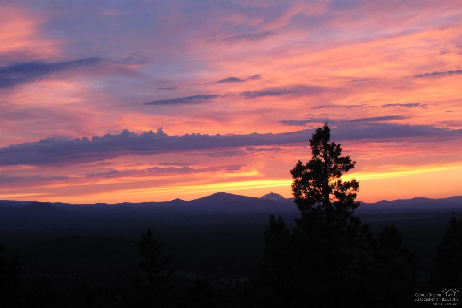 Relish the 270 degree views from this luxury Awbrey Butte home. A flat driveway leads to main floor living with master & office on the main and 3 bedrooms & bonus room in the walk-out lower level. The gourmet kitchen overlooks the open great room and out to the expansive deck you'll love for entertaining or just watching the sunset. Choose from casual or formal dining. Look out to the Cascade Mountains or over to Smith Rock from the impressive master suite - you'll never get enough of these views!