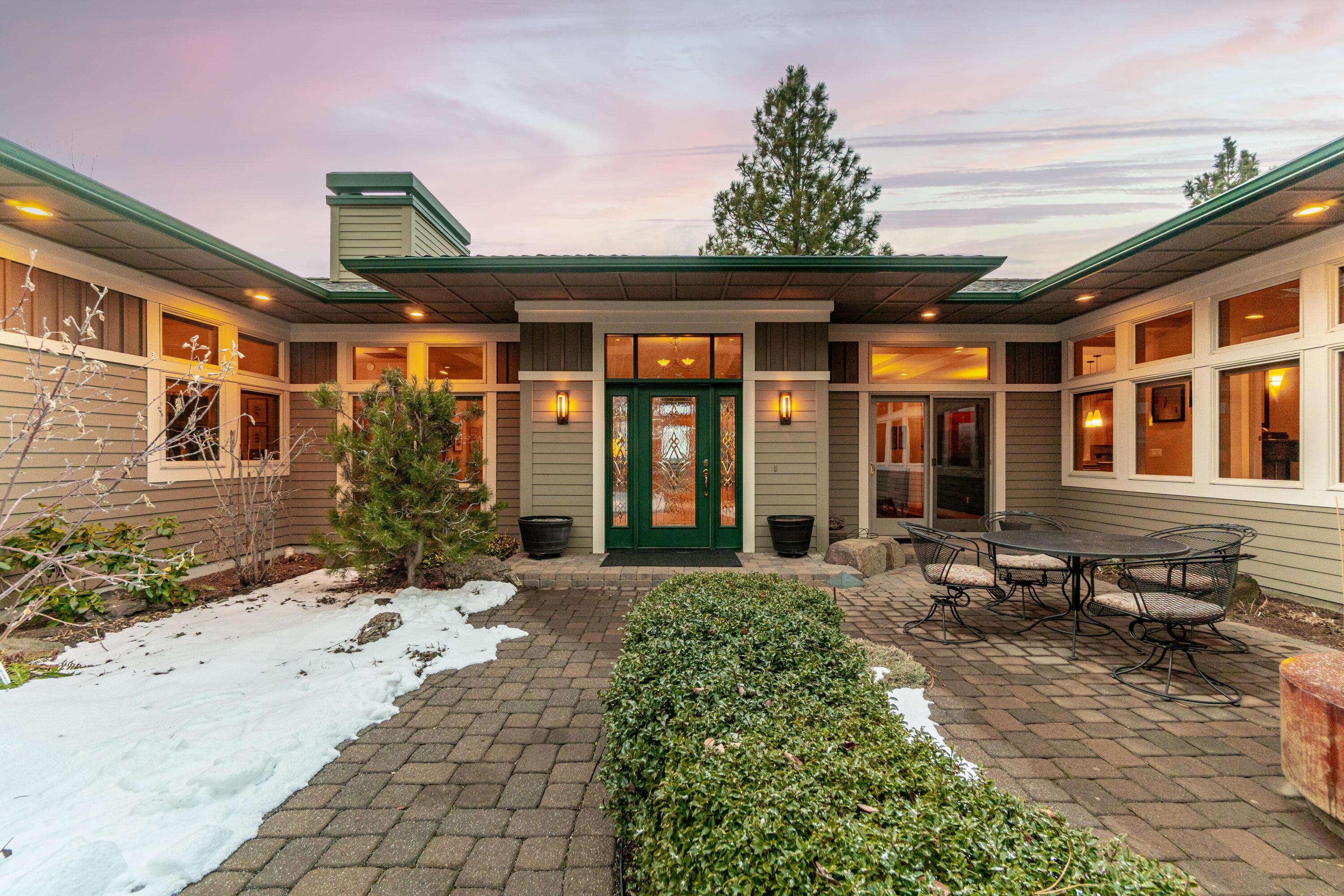 Timeless and elegant, this quality built and meticulously maintained
NW contemporary custom home is light, bright and spacious with
stunning panoramic mountain views and beautiful outdoor spaces.
Enter through a garden like, fully enclosed courtyard to an open great
room w/gas fireplace and dining area that leads to a covered outdoor
deck for relaxing, entertaining and soaking in the mountain views.
Main floor incudes a gourmet kitchen with custom cabinetry. Primary
Suite w/luxury bath, walk in closet and private courtyard. North wing
features a dedicated office w/ built ins and guest suite for a nice
separation of space. Two separate staircases access a
huge finished daylight basement that features an additional Primary
Suite with living area, bed and bath, dedicated office/bonus room and an
addt'l recreation space with outdoor access. Three car garage.
Wonderful opportunities for multigenerational living. Fabulous
Awbrey Butte location near excellent schools, shopping and medical.