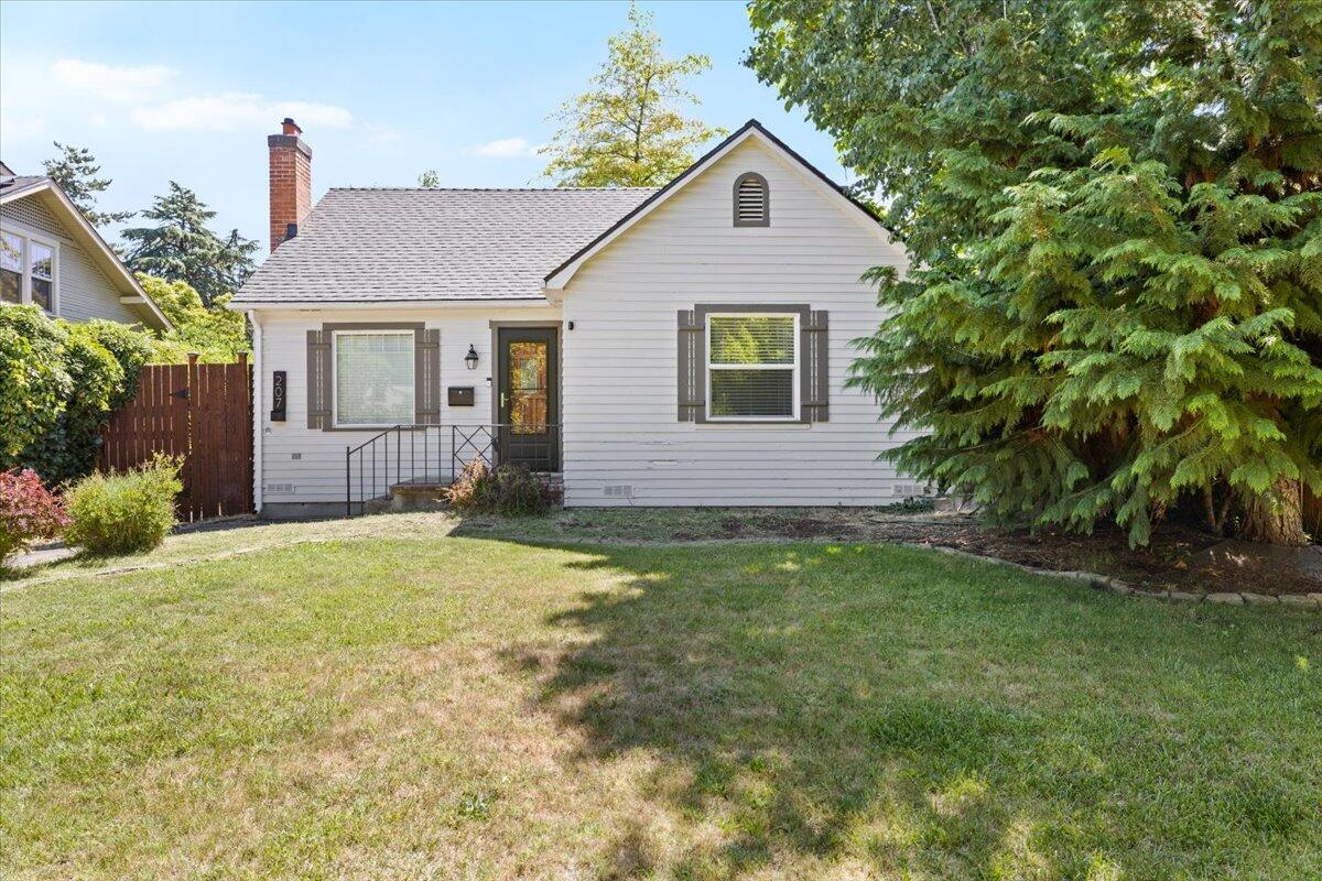 Back on Market - No Fault of Property!!  Thoughtfully remodeled East Medford home blending charm with modern upgrades! Converted from a 3 bed/1 bath to a spacious 2 bed/2 bath layout, this home features original hardwood floors, a cozy living room with a white brick fireplace, and abundant natural light. The kitchen offers cute and quaint that meets functional flow. Major updates include a new roof in 2024, brand new range hood, updated electrical, and a central AC unit installed in 2021. Both bedrooms are generously sized. Enjoy a landscaped front yard, a private fenced backyard with alley access, and a detached shop—ideal for hobbies, storage, or a home gym. Located on a quiet street in a desirable neighborhood, this move-in ready gem is a must-see!