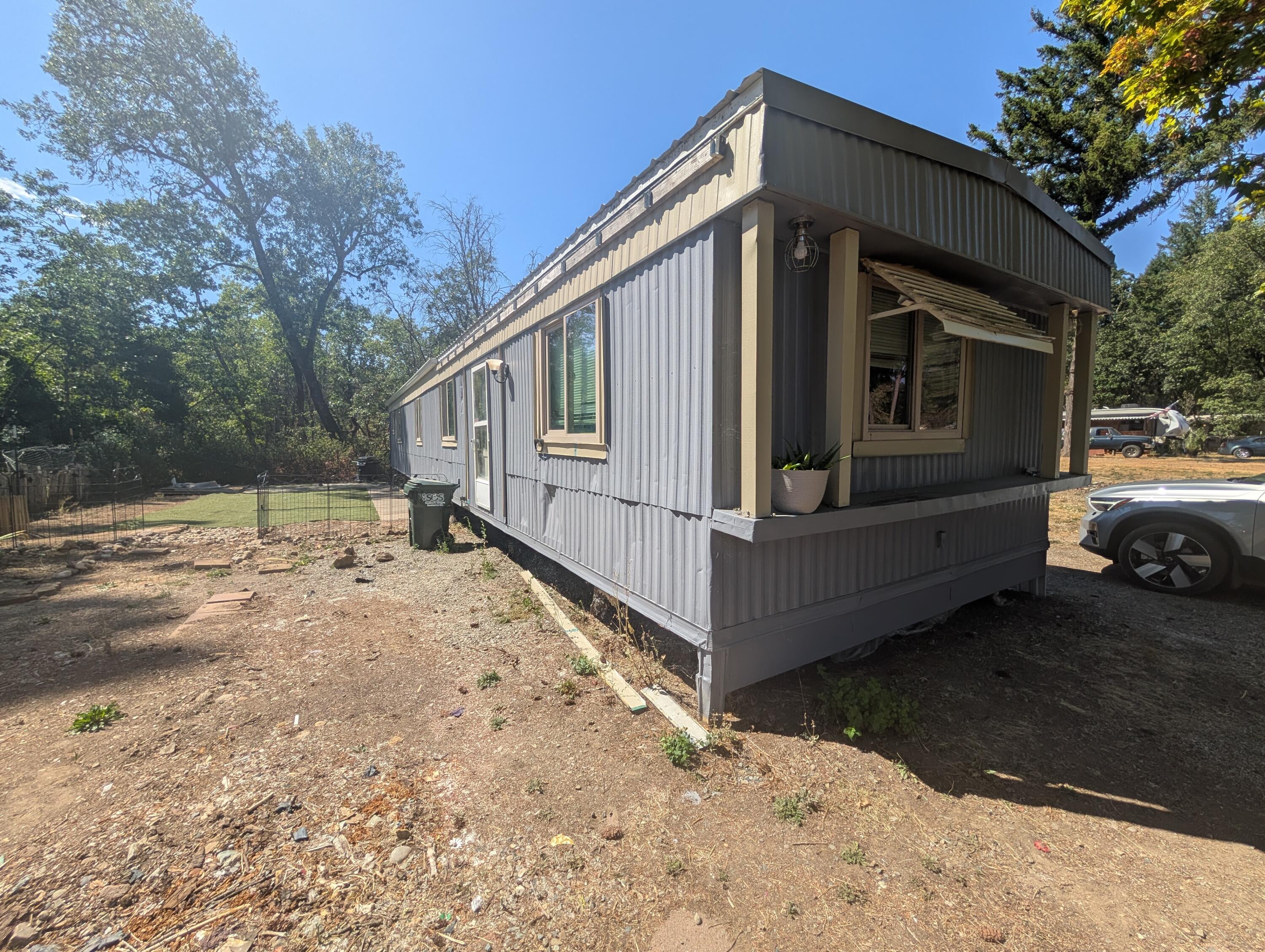 This 1976, 924 sq ft, 2-bedroom, 2-bath mobile home in Kerby is a fantastic fixer-upper opportunity for investors or handy buyers looking to build equity. Offering good natural light, a spacious feel, with a small yard area, this home is ready for updates and finishing touches to bring it back to life. Conveniently located near Hwy 199 with easy access to Grants Pass and the Oregon Coast, this property is ideal as an affordable residence or flip project.