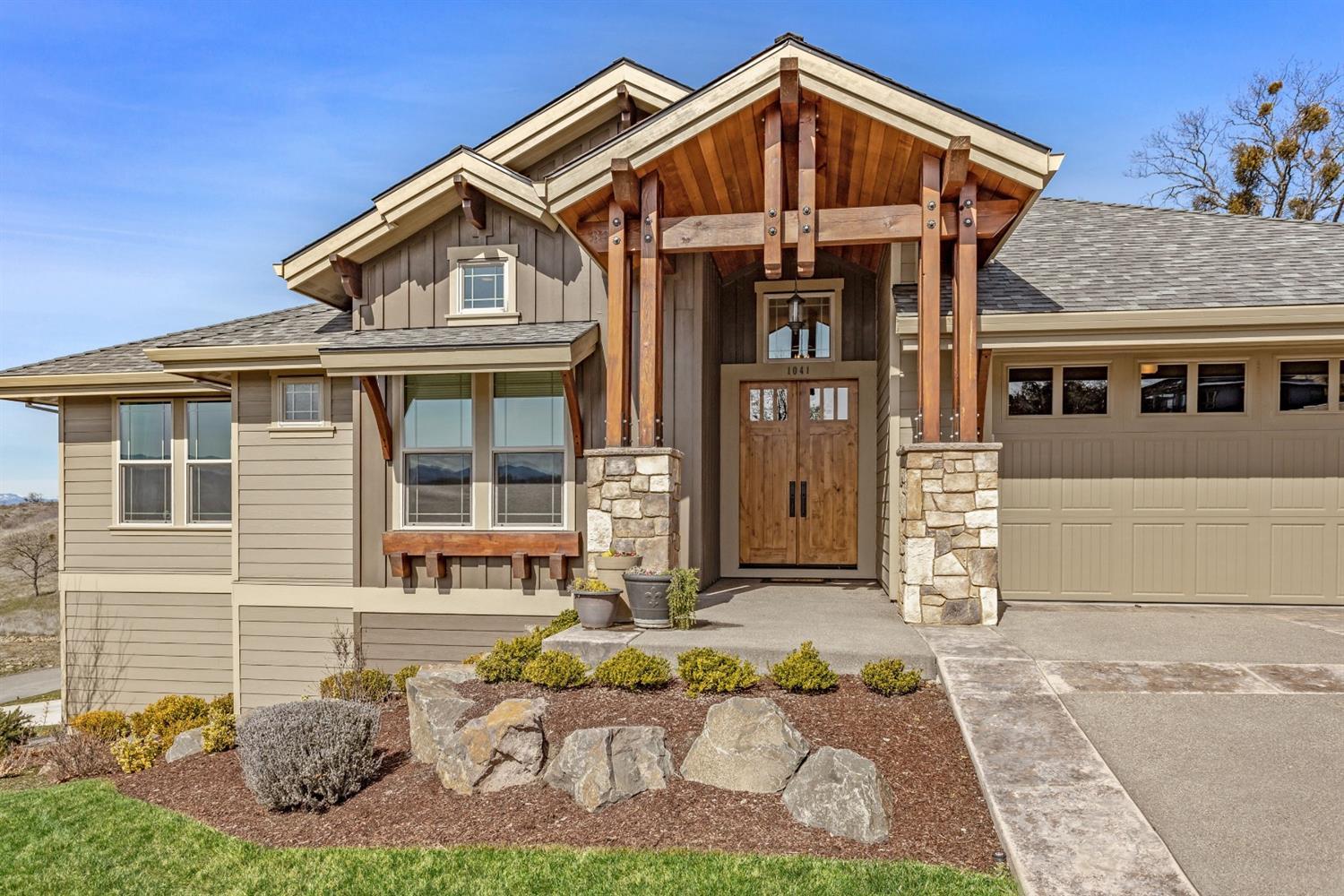 Treat yourself to a one level East Medford home with beautiful views! You must see this charming and extremely functional 2438 sq. ft. craftsman style home featuring an open floor plan and high-quality upgrades. This home is built for relaxing indoors or outdoors by the pool and entertaining throughout. It features 3 bedrooms, 2.5 baths (as well as an additional bath in the lower level garage), 2-two car garages, wet bar, and a covered patio with a custom swimming pool. Perfect for growing families or retirees who want extra shop or garage space and who love to entertain. The home includes a sound system, outdoor gas fire pit, solar pool heating system, fenced raised garden and excellent landscaping. Large covered patio area that leads to the pool and your totally private backyard! Innsbruck Ridge is a gated upscale subdivision at the base of Roxy Ann.