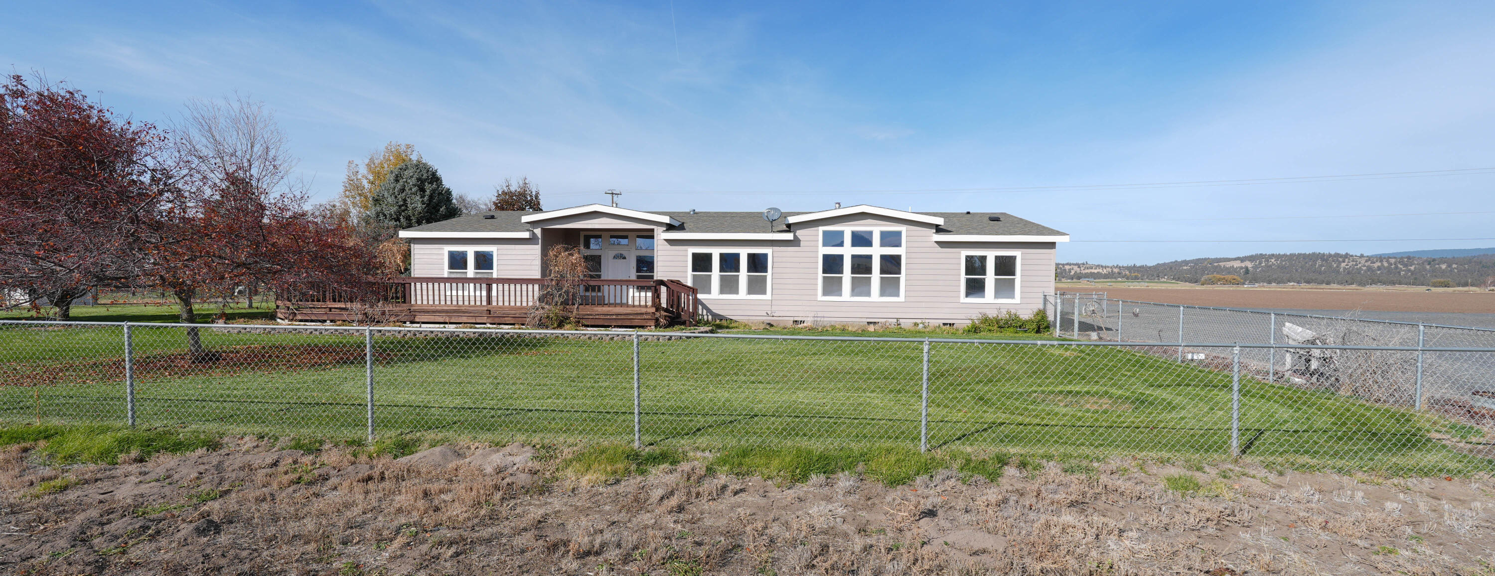 Spacious Home on 1.11 Acres- Bonanza Charm!!  Two tax lots with plenty of room inside and out in the small town of Bonanza.  The 2001 MF offers 2,785 sq. ft. with a freshly redone interior and exterior, featuring a beautifully remodeled primary bath with bonus room in primary suite and huge walk-in closet.  Open, comfortable layout with space for everyone-- living and family room, dining area and kitchen eating areas, along with three more bedrooms and two full bathrooms. Outside you will find a detached garage/shop with cement floor, metal roof, two roll up doors and electricity.  There is a nice paddock area and shelter with panels- perfect for a horse or livestock projects.  Home has its own well, hooked up to city sewer and Avista for natural gas. Enjoy quiet country living with the convenience of being close to town.