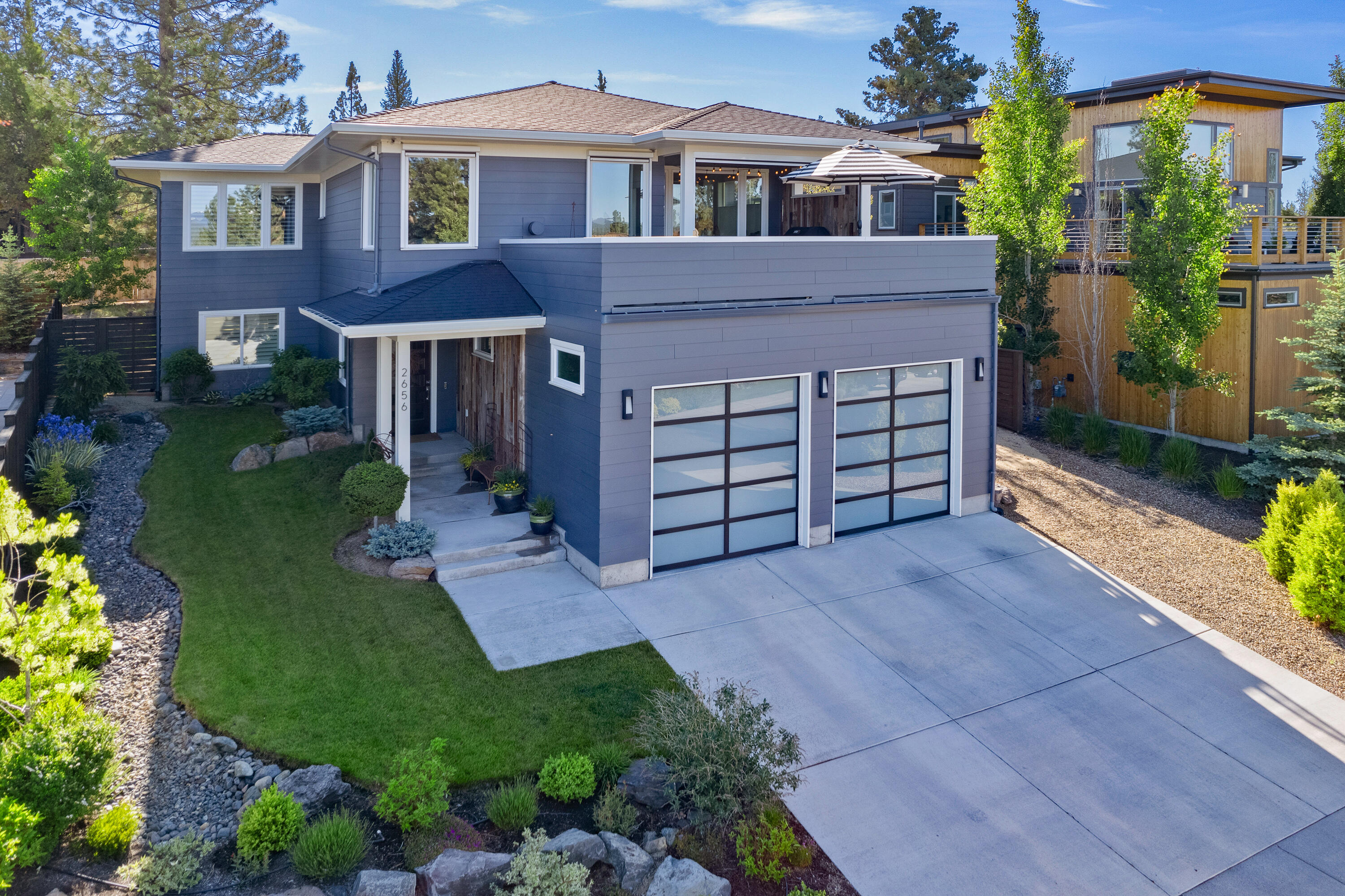 Perched among the treetops with amazing Cascade Mountain views, this 2017-built custom home offers upstairs main living for ultimate privacy and stunning western vistas. This NW contemporary is loaded with upgrades including Thermador Pro series kitchen appliances, California Closets throughout, hand-scraped solid hickory floors and electric solar shades on the west-facing side of the home. 2633 sq ft of interior space with expansive great room and kitchen with quartz countertops, 3 bedrooms, 2.5 bathrooms and an oversized 3 car garage. Off the great room is a stunning outdoor living area which is set atop a partially covered deck with panoramic mountain views and a custom fire pit – ideal for year-round enjoyment. Meticulously maintained, this residence also has radiant heated floors in several spaces as well as a ductless heating/cooling system providing multi-zone climate control. Explore this one-of-a-kind home in the quiet community of Marken Heights and get ready to fall in love