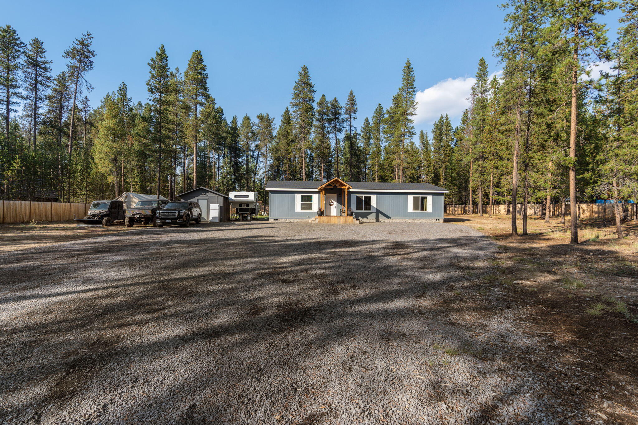 Great home located in the pines. Built in 2020!  3 bed 2 bath home on 1.37 acres.  Property is completely fenced for privacy. Great garden space with a cute greenhouse. Large, covered area and firepit right out your backdoor perfect place to entertain. 10x14 Shed wired/220 can store your toys or use it as a hobby shop. Drive right down the road to access the BLM.