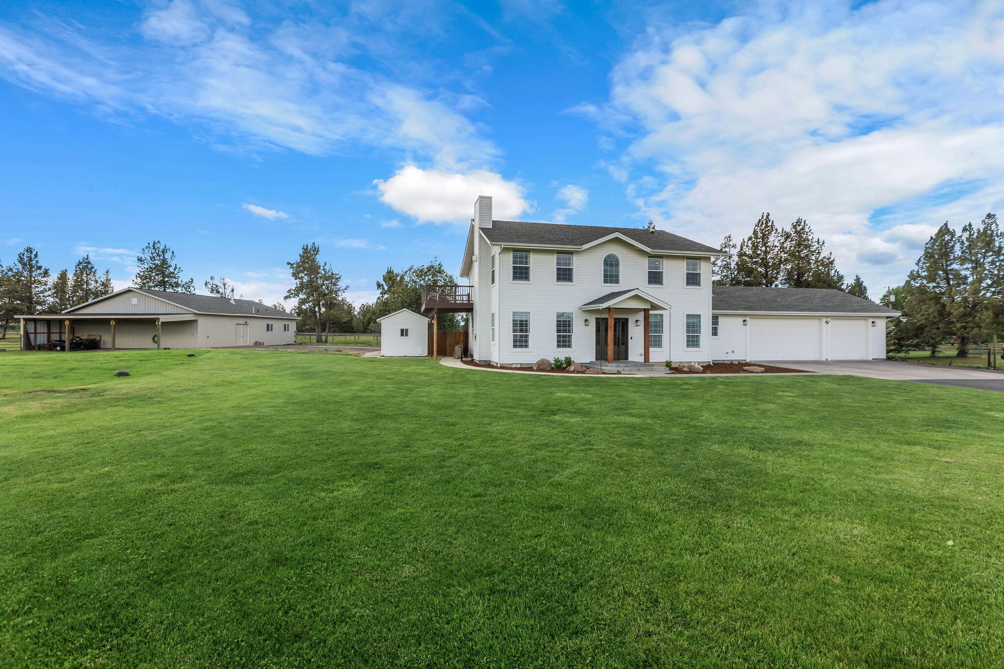 Prepare to fall in love with this stunning farm property! It's everything you're looking for - a gorgeous, luxury, custom farmhouse home with breathtaking, pastoral and kitchen window views of the snow capped Cascade Range. This property includes a sizeable workshop with RV parking and ADU potential.  Additionally, you'll find almost 4 irrigated farm acres, full fencing, and a pond. Other highlights: paved driveway, farmhouse front porch, back yard paver patio with hot tub, and garden shed. The NEWLY remodeled home boast light and bright quartz countertops with brand new beautiful dark wood cabinets.  Hard wood floors through out with tile back splash in kitchen and bathrooms. This dream property is a must see and a rare find in this very DESIREABLE area of SW Redmond- You'll find you won't want to walk away!