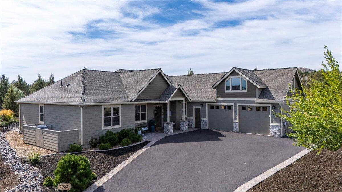 Discover unparalleled  resort style living in this exquisite Custom Northwest style golf course home located on the 8th Fairway of the Challenge Course in The Falls 55+ community on a tranquil cul de sac. This single level 4 bedroom, 2.5 bath residence offers an inviting open floor plan perfect for seamless indoor & outdoor entertaining. Highlighted by vaulted ceilings, custom built ins and showcase fireplace the great room is ideal for relaxation and entertaining. Laundry room/ butlers pantry provides ample storage space  Wall of windows provides abundant natural light as well as showcasing the private, professionally landscaped backyard with custom bocce court, fire pit, serene water feature and covered patio perfect for al fresco dining. The chef's kitchen boasts a large soapstone island, breakfast bar & quartz counters and pantry. This home offers separation between primary and guest bedrooms and  spacious bonus room above the oversized 2 car garage with workshop area.
