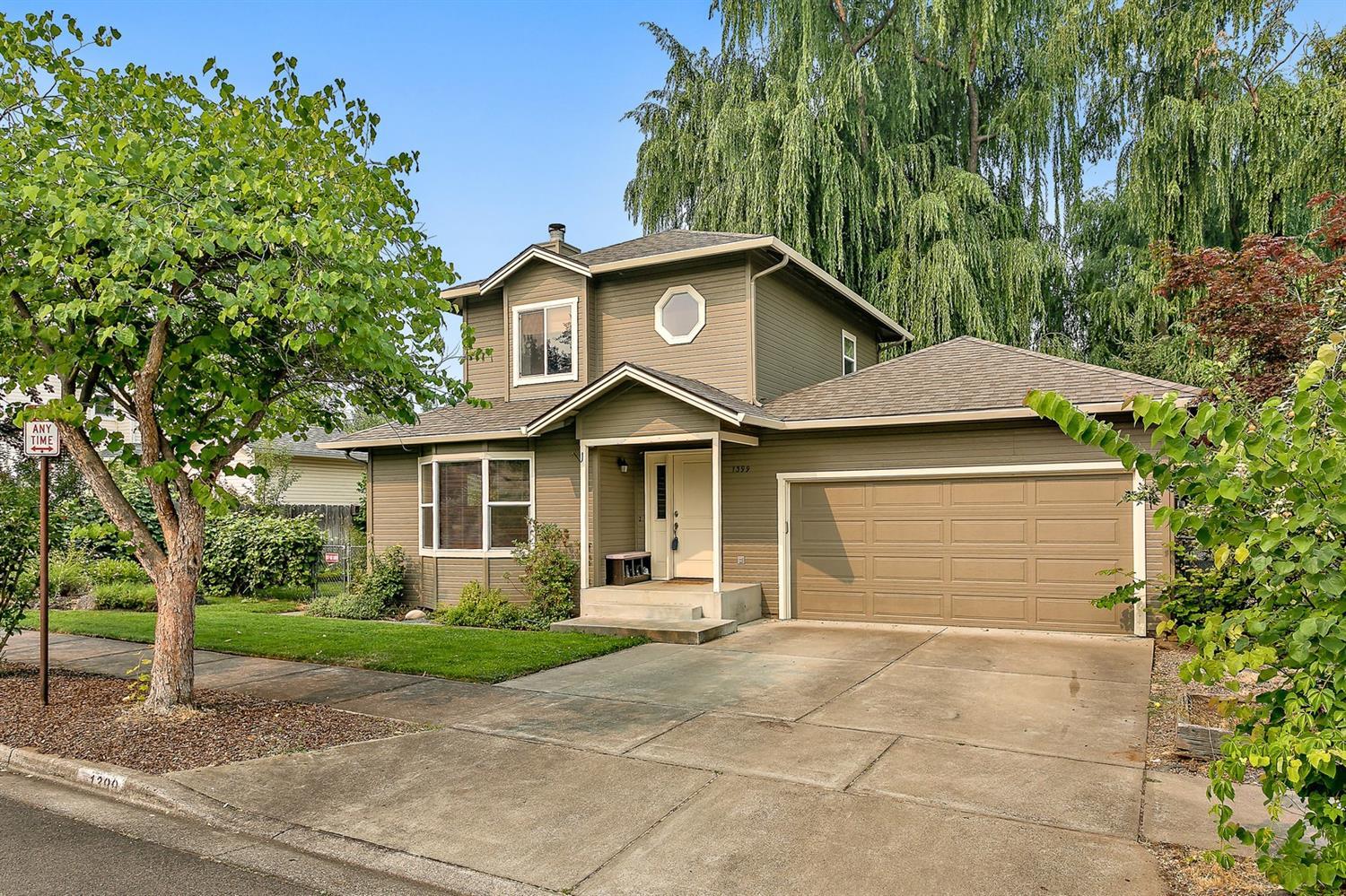 Sweet Millpond home! This 1565 square foot, well-cared for home is in a great neighborhood and offers lovely interior spaces. Cheerful and sunny interior with lots of character including wide arched doorways, wood flooring, open living room with tile surround fireplace, dining room & kitchen. 2 bedrooms on main level and spacious upper level master suite with additional bonus room. Great yard with patio that backs to flowing canal. Recent upgrades over past few years include roof, doors, cabinetry, heat pump, interior and exterior paint, lighting fixtures and hardware. Close to schools, downtown, parks, shopping. Double car attached garage.