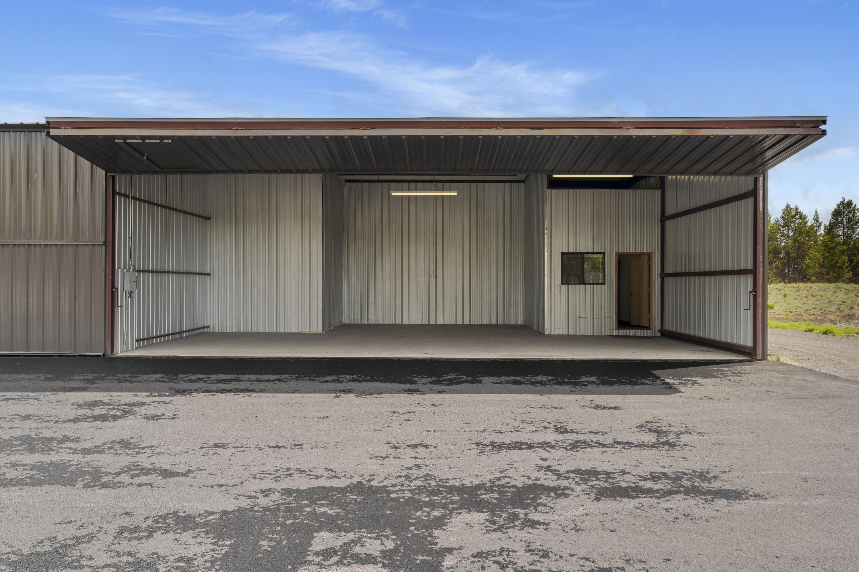 Rare Sunriver Hangar Opportunity! Calling all pilots and adventure seekers—here's your chance to own a highly sought-after 1,597 Sq. Ft. end unit hangar in Sunriver! This versatile space includes an approximately 40' wide x 33' deep hangar bay with a door height of  approx. 11.5', perfect for storing your aircraft. Attached is a 13' x 9' office and a convenient 13' x 9' loft storage area above, accessible by stairs on the storage side. Office has a wall heater.  A separate two-bay garage offers approximately 20' x 18' of space with an approx 9' tall door—ideal for vehicles, recreational gear, or additional storage. These connected units are being sold together and will not be offered separately. A rare find in a prime location—don't miss out!