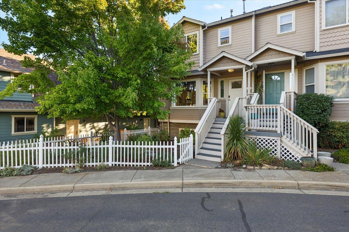Stylish End-Unit Townhome with Clay Creek Setting! Prime Ashland location near shopping, schools & restaurants. 1,569 sq ft, 2 Bd/2.5 Ba + BonusRm on .07 ac lot with fenced front yard. Enjoy 2 balconies overlooking peaceful Clay Creek and mature trees. Bright living room with hardwood floors, gas fireplace, open kitchen with soapstone island, gas range, refrigerator, half-bath & dining area with deck access. Upstairs are 2 bedrooms, each with private bath, plus laundry (W/D incl). Primary Suite has vaulted ceilings, walk-in closet, tiled bath & balcony. Gas furnace, gas water heater, A/C & owned solar system powering entire home! Handy 2-car garage + BonusRm. HOA $175/Qtr maintains common areas. Move-in ready!