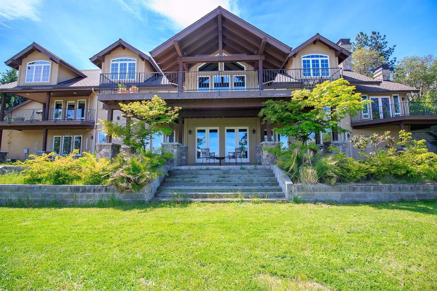 Would you like to live in the heart of Southern Oregon's wine country, in a charming, historic town, with lots of fresh air, and little traffic? Would you like your home to have a beautiful view of the mountains, and space to entertain, yet offer easy access to medical care, shopping, fishing and hiking? Your dream home awaits! This elegant hilltop home features a gourmet kitchen, two private main-level master suites, one with an ADA accessible bathroom making a perfect two family set-up. Downstairs has a family room, three bedrooms and two baths. Upstairs has an office space for work-from-home types, and a large bonus room that would make a perfect art/yoga studio. Also inc. is a detached shop that is heated and cooled for year-round projects. Watch the sunrise from the large deck and private balconies, cozy up to one of the three fireplaces, or venture out and enjoy all of the culture, arts, and cuisine that Southern Oregon has to offer! Please see attached video walk-through.