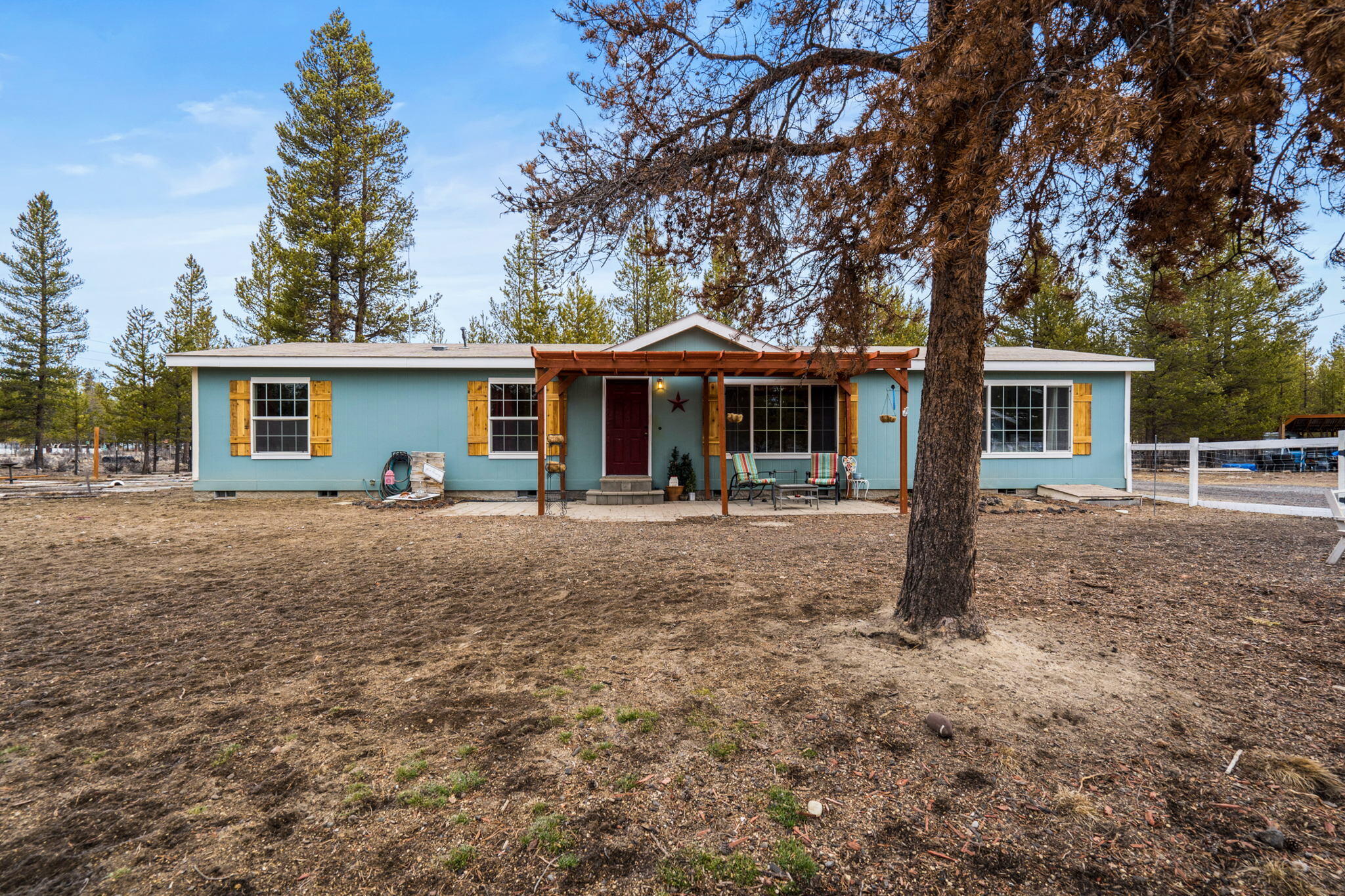 Quiet country living on 0.94 fully fenced acres that backs to BLM. Newly painted & renovated 1,728 sf manufactured home. Main living area is an open concept space w/ decorative accents, laminate flooring & an abundance of natural light throughout. Open kitchen ftrs central island, breakfast bar seating, double oven, plenty of cabinetry for storage, large walk in panty, all appliances included, plus a large eating area.  Home also features a separate family room! Primary bedroom ftrs barnwood look decorative wall, carpet, large window, built in shelving, & walk-in closet. Large primary bath has corner soaking tub, large frosted window for natural light, dual vanities, & walk in shower. Two additional bedrooms share a full bath off that additional family room. Outside you'll find a patio w/ pergola, small deck, gardens, greenhouse, chicken coop, shop w/ 30am RV hookup, new heat pump, new well! Bring your toys & play in the mountains, lakes, desert & all that Central Oregon has to offer!